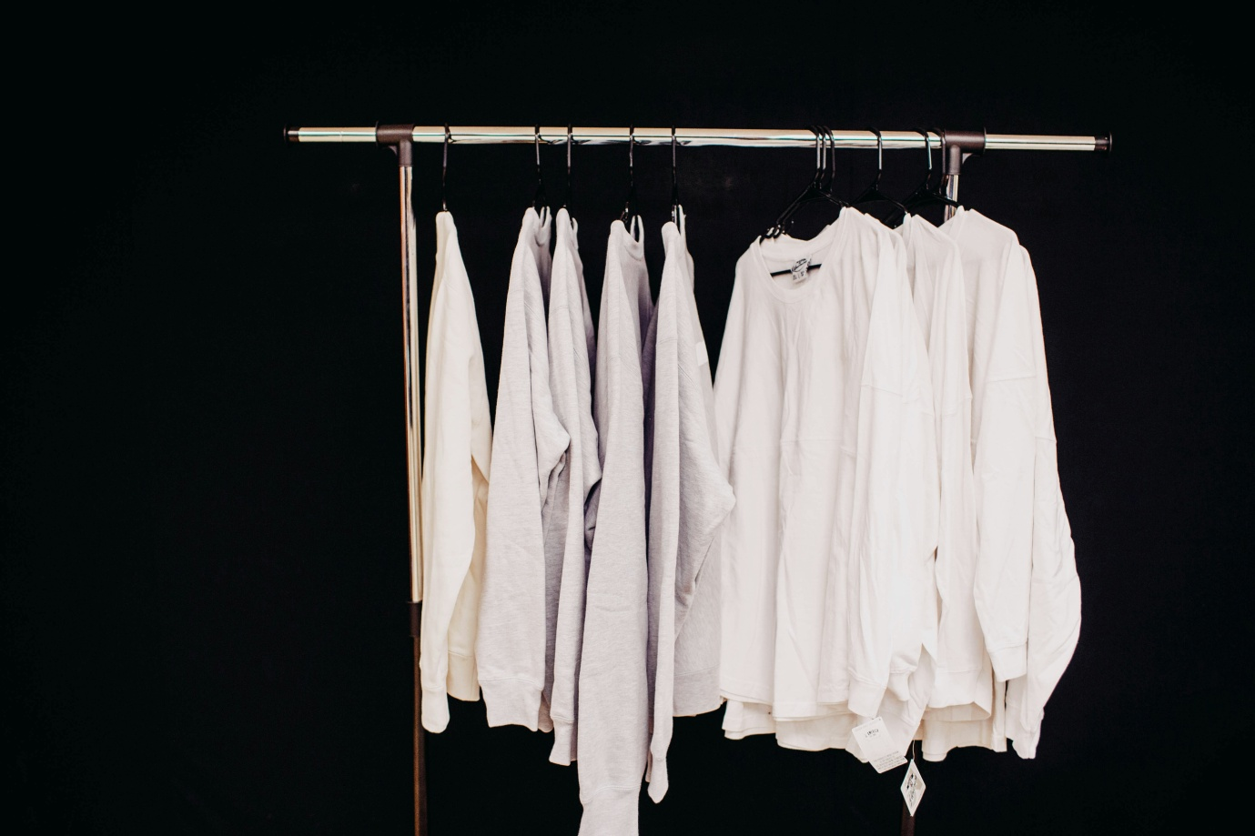 A rack of white clothes manufactured by Lefty Production Co.