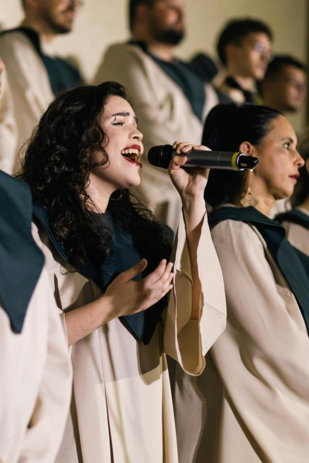  A woman wearing a choir robe manufactured by Lefty Production Co.