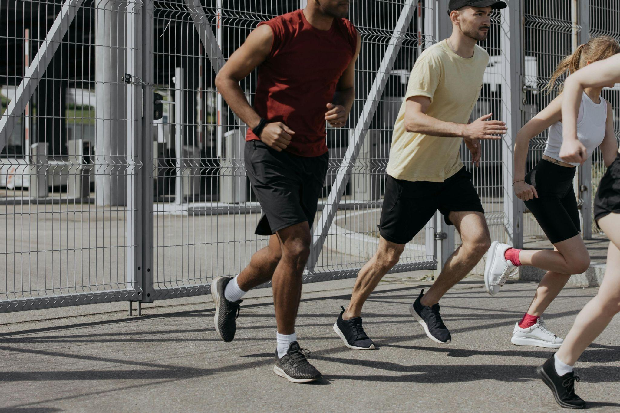  Group of people running outdoors wearing performance athletic apparel