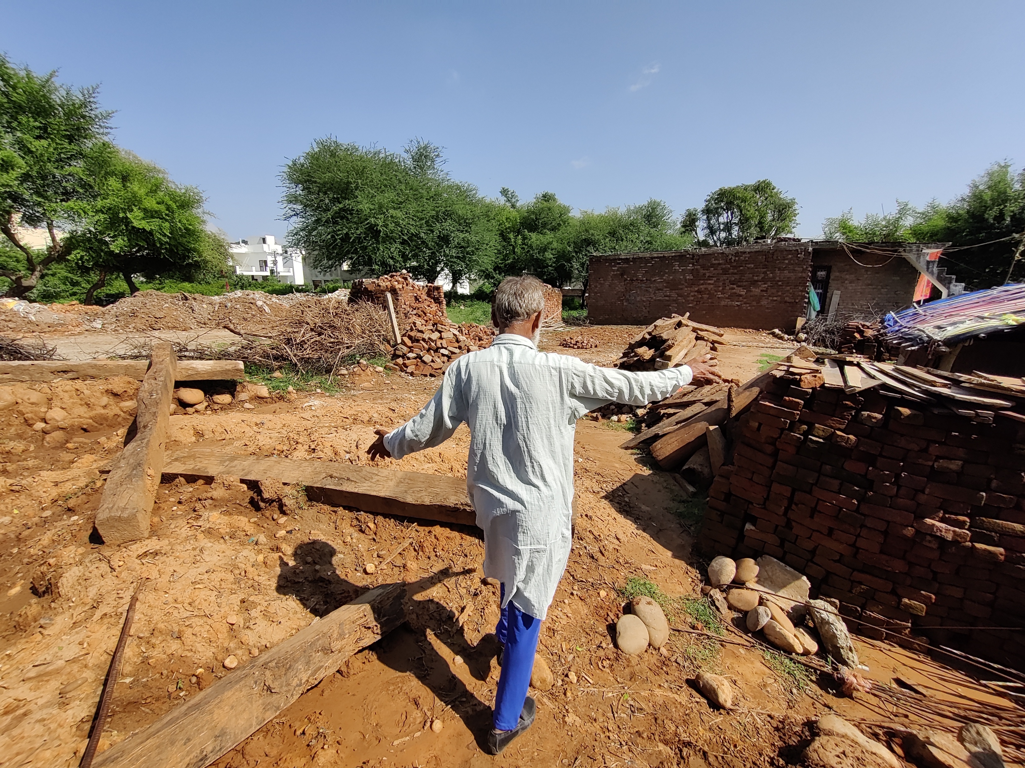 One of the Ali brothers showing the site of a demolished mud-hut that belonged to his parents in Paloura, Jammu.
