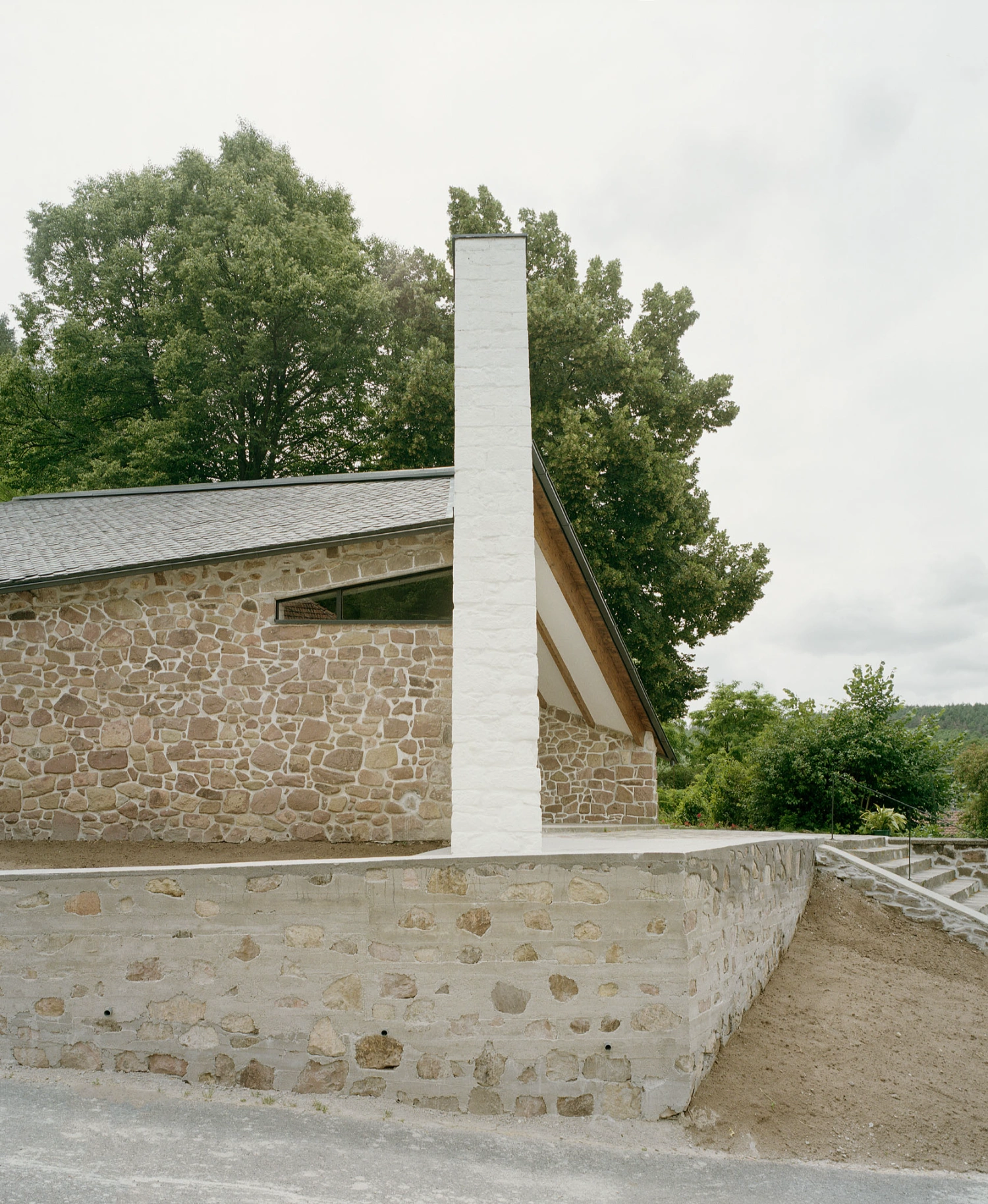 Church of Cserépváralja restoration showing stone walls and new concrete ramp, sacral architecture, Hungary