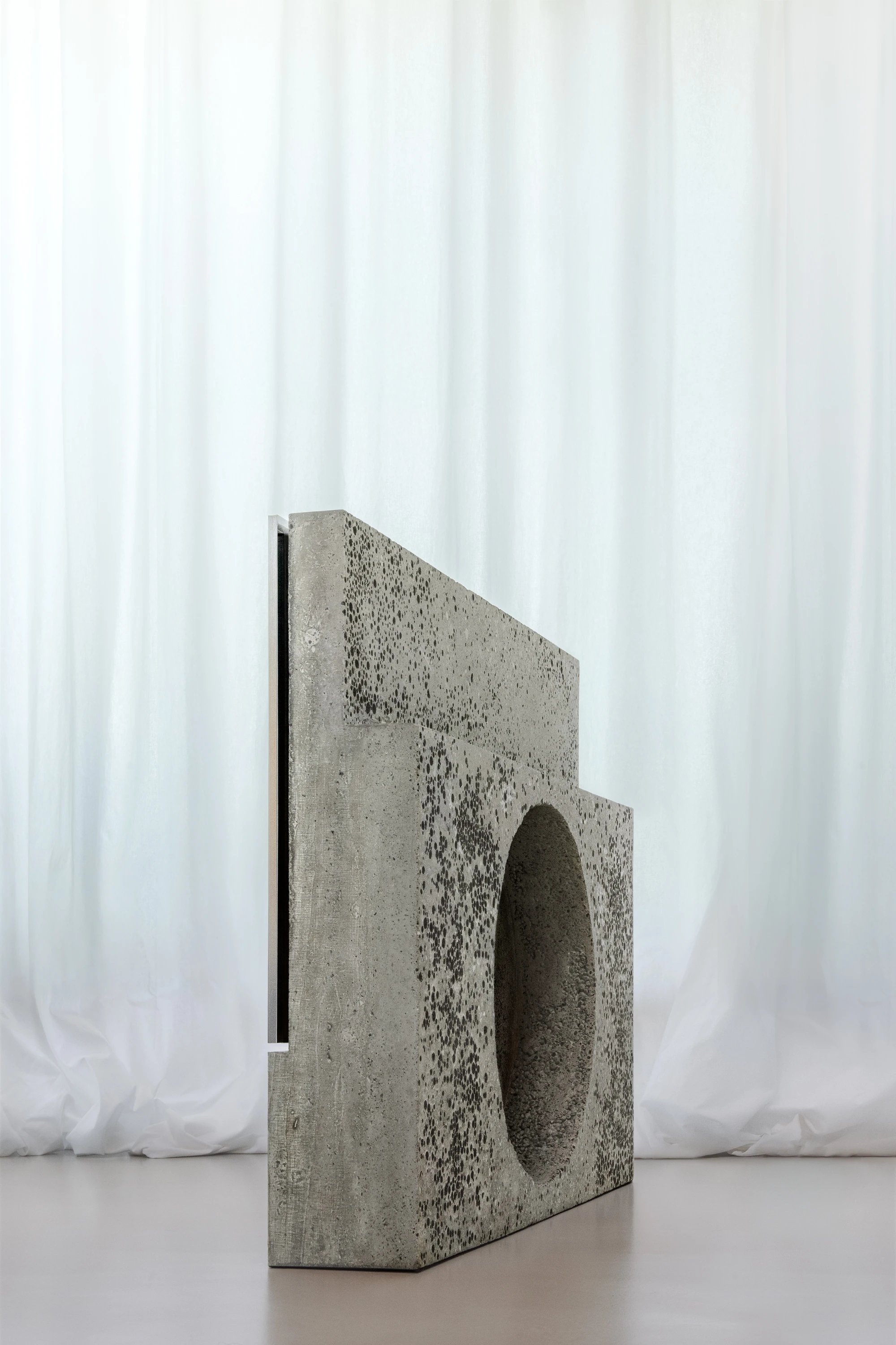 Concrete TV Stand sculptural media furniture by David Bard with meteorite-like base
