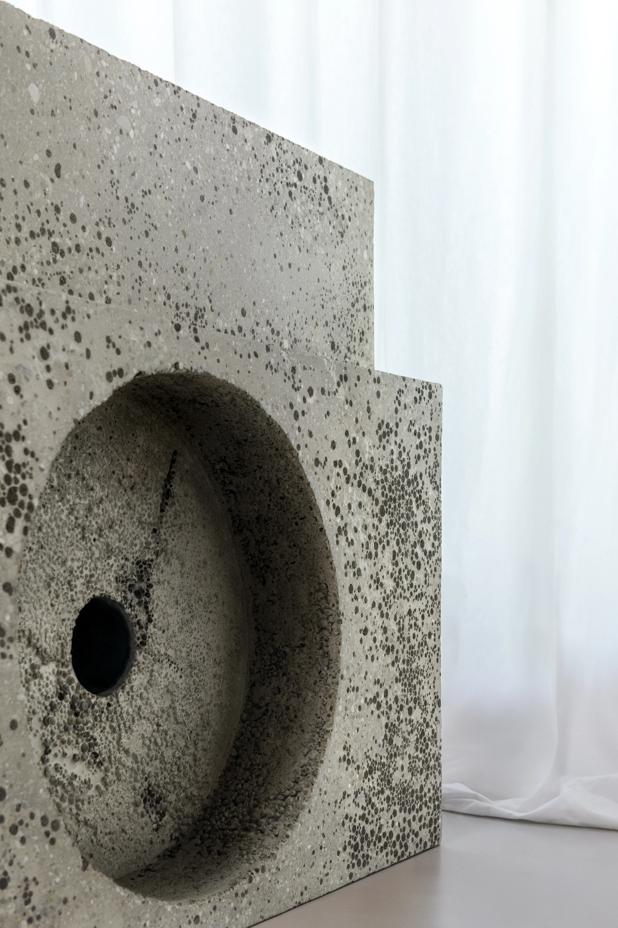 Concrete TV Stand sculptural media furniture by David Bard with meteorite-like base