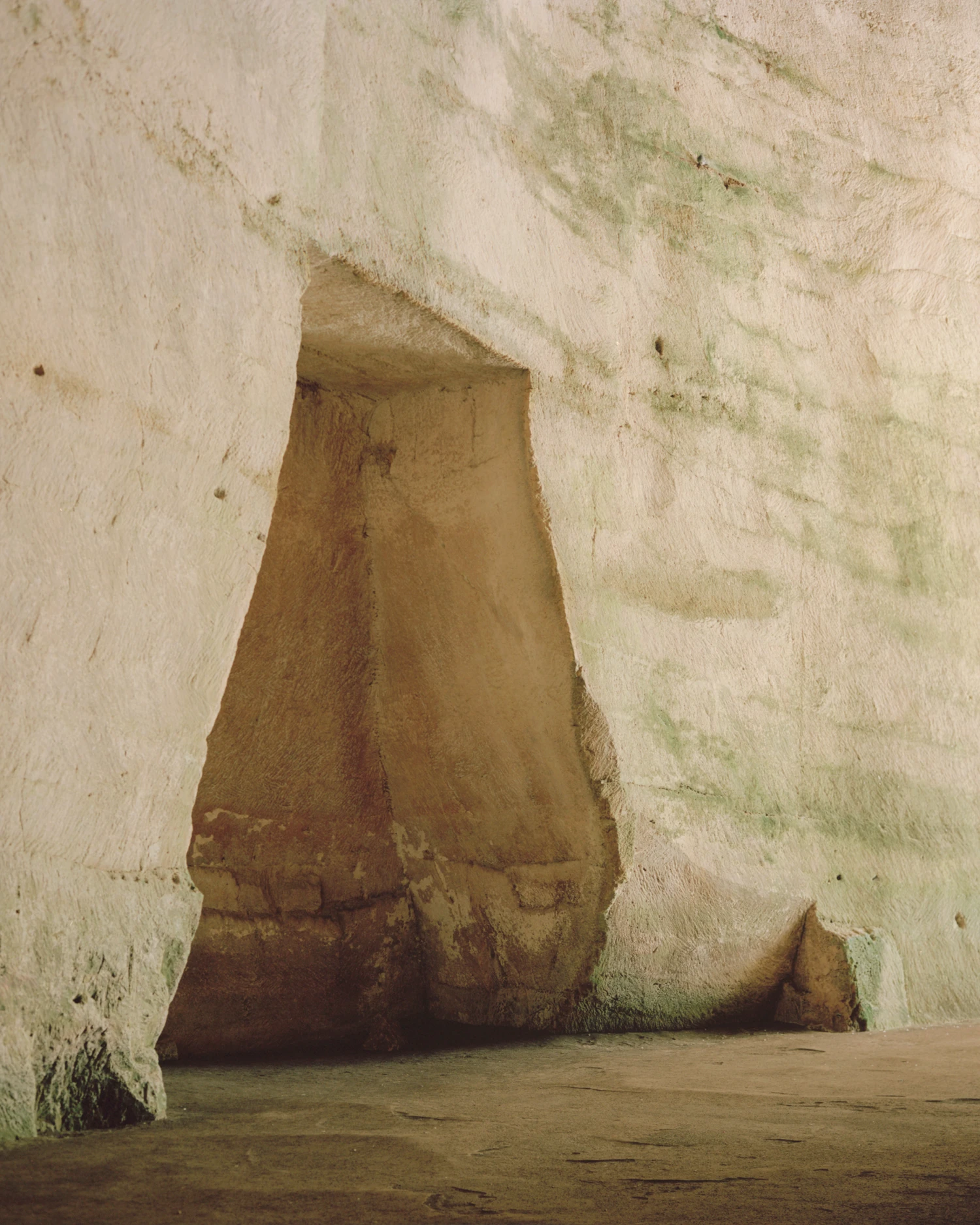 Pantalica Speculations by Leopold Banchini, An asymptotic timber and stone pavilion on a seaside promenade overlooking the Mediterranean, dark wood frame supporting stone-tile roof on massive limestone blocks