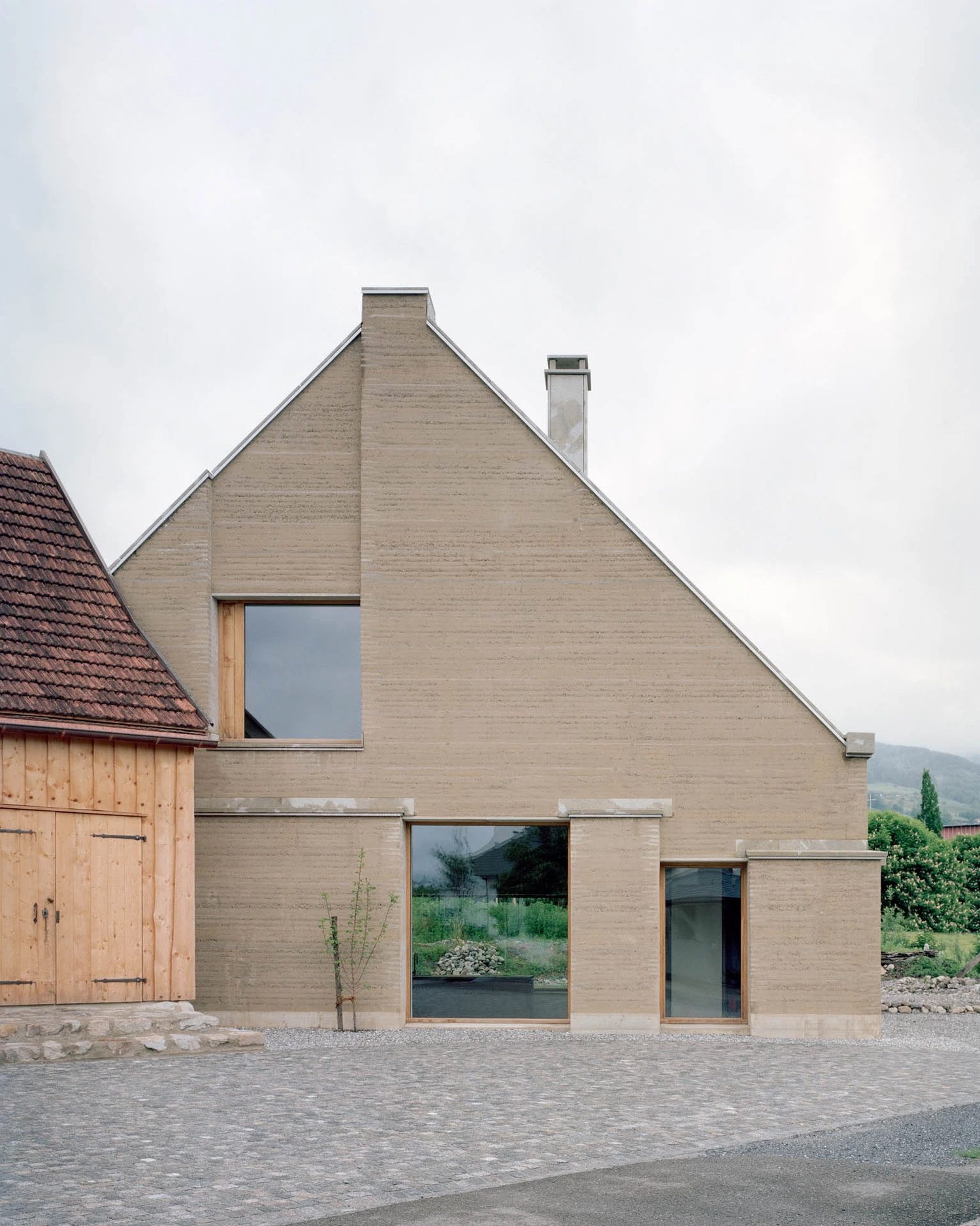 The Gässli5 by allen + crippa architektur in Werdenberg Switzerland, rammed-earth and historic log house with permaculture garden, sustainable circular architecture