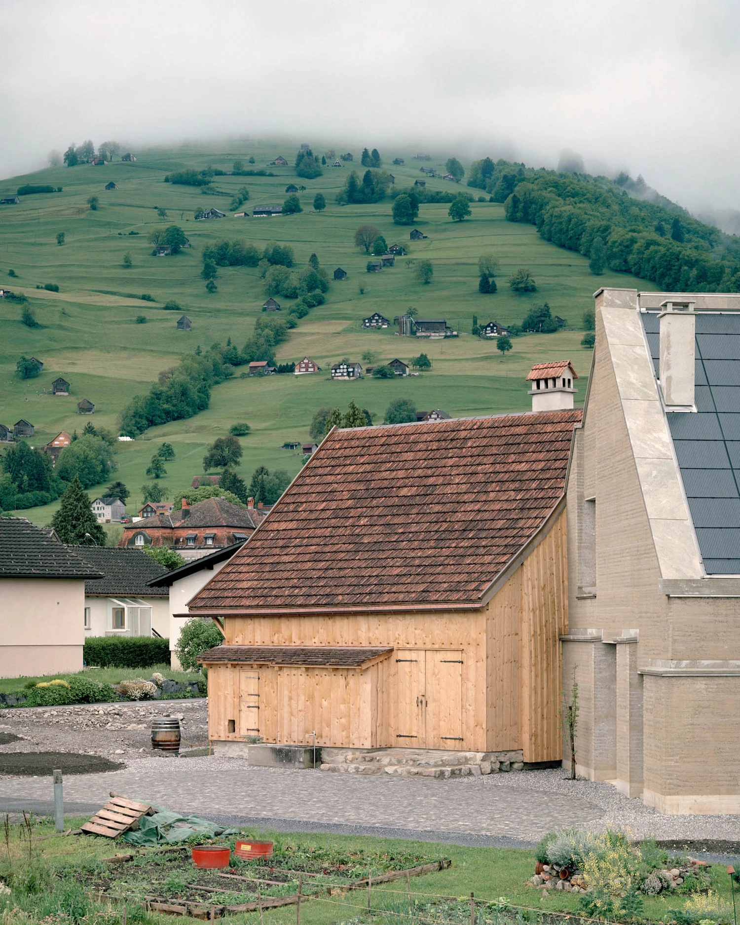 The Gässli5 by allen + crippa architektur in Werdenberg Switzerland, rammed-earth and historic log house with permaculture garden, sustainable circular architecture