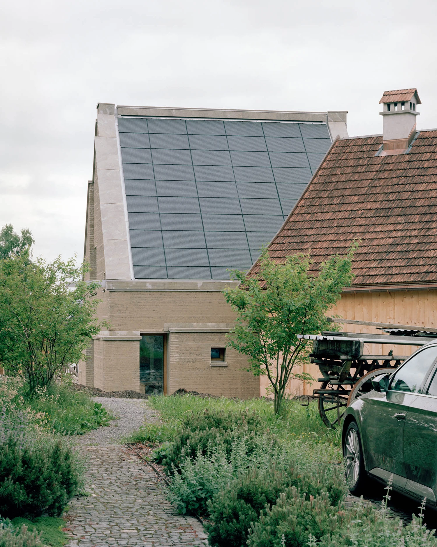 The Gässli5 by allen + crippa architektur in Werdenberg Switzerland, rammed-earth and historic log house with permaculture garden, sustainable circular architecture