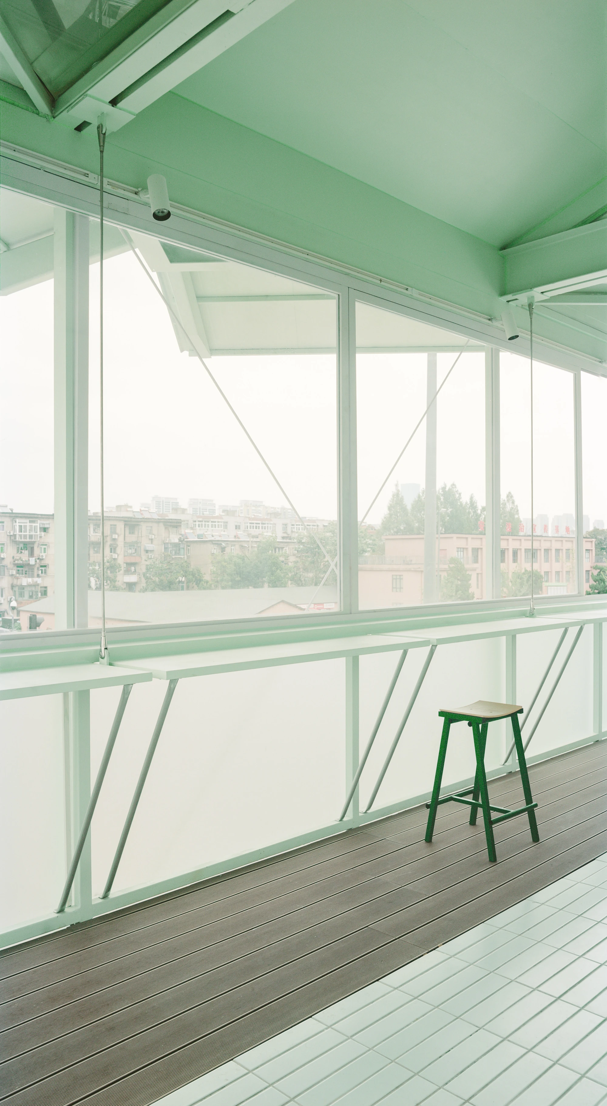 A Very Small 24-hour Bookstore by SZ-Architects in Hefei China, adaptive reuse guard tower converted to public reading space, suspended steel structure with four-leaf clover roof