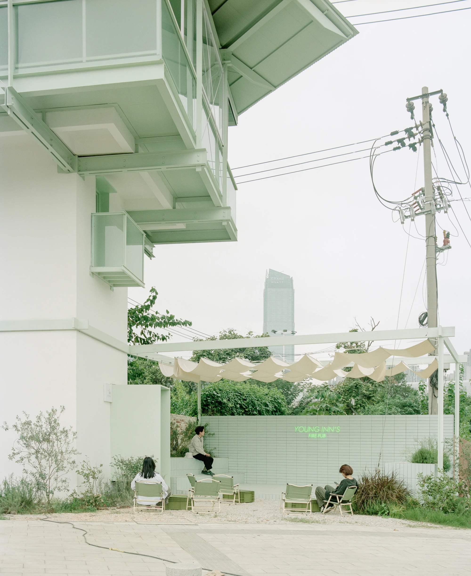 A Very Small 24-hour Bookstore by SZ-Architects in Hefei China, adaptive reuse guard tower converted to public reading space, suspended steel structure with four-leaf clover roof