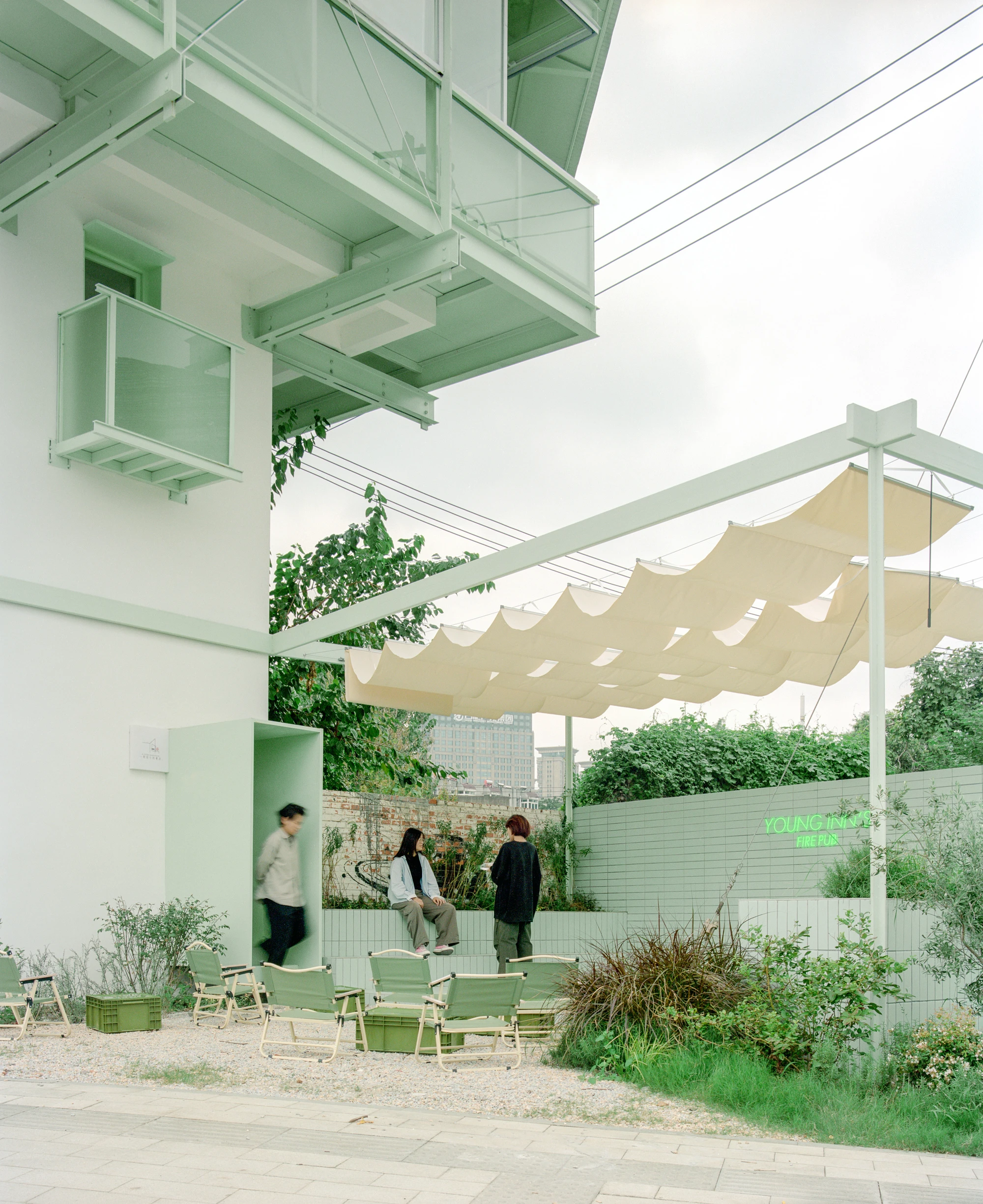 A Very Small 24-hour Bookstore by SZ-Architects in Hefei China, adaptive reuse guard tower converted to public reading space, suspended steel structure with four-leaf clover roof