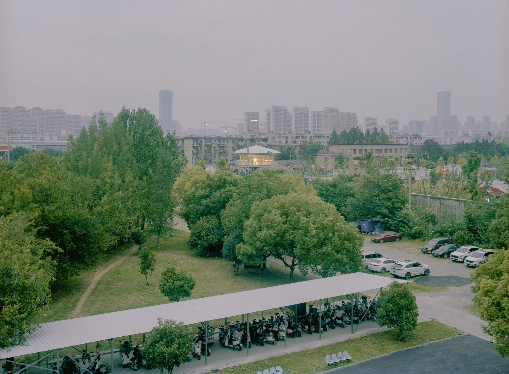 A Very Small 24-hour Bookstore by SZ-Architects in Hefei China, adaptive reuse guard tower converted to public reading space, suspended steel structure with four-leaf clover roof