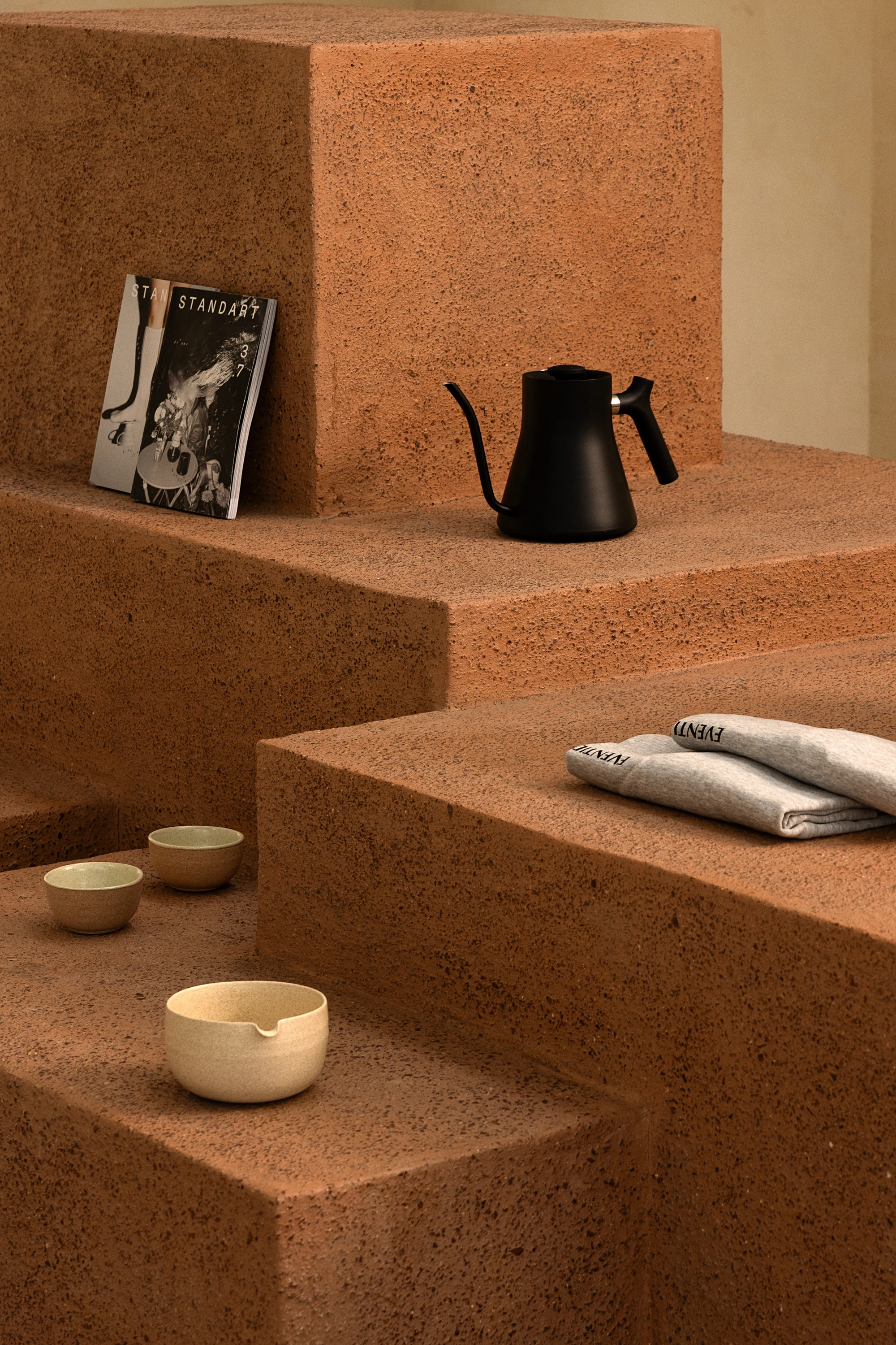 Eventide Coffee by BILLBOARDS in Chennai India, coastal cafe interior with elliptical counter and skylight, earthy tones and curved architectural elements inspired by the Madras beach