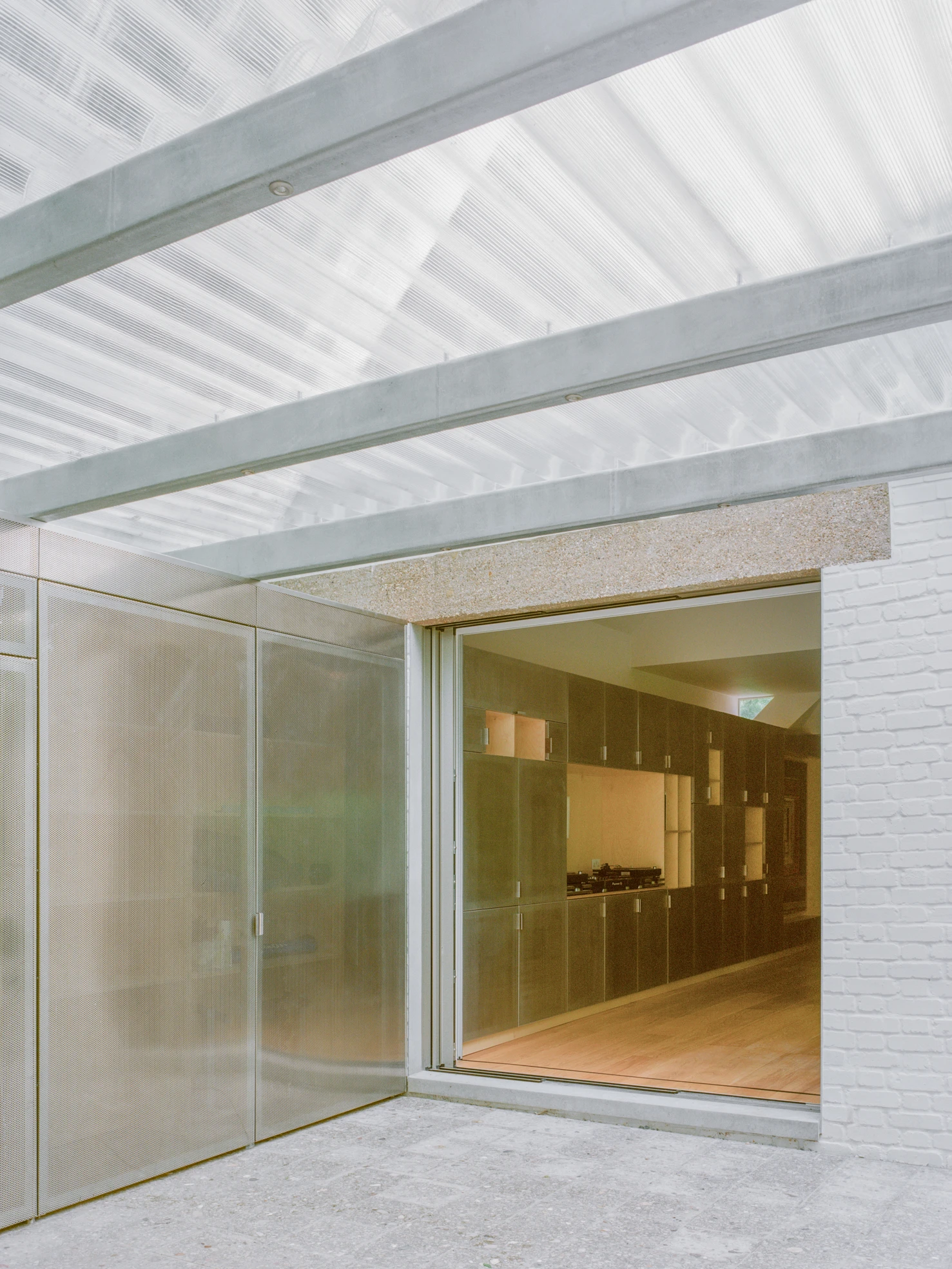 Exeter Road Pavilion by Neiheiser Argyros in London UK, adaptive reuse Victorian outbuilding with perforated stainless steel cabinet marble counterweight and Fischli Weiss inspired structural precarity