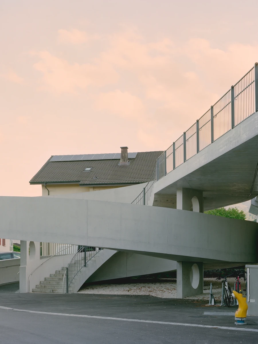BLT Linie 19 Hölstein Süd tram stop by Raeto Studer Architekten in Switzerland, exposed concrete ramp and staircase infrastructure with 540-degree spiral and 55m concrete girder