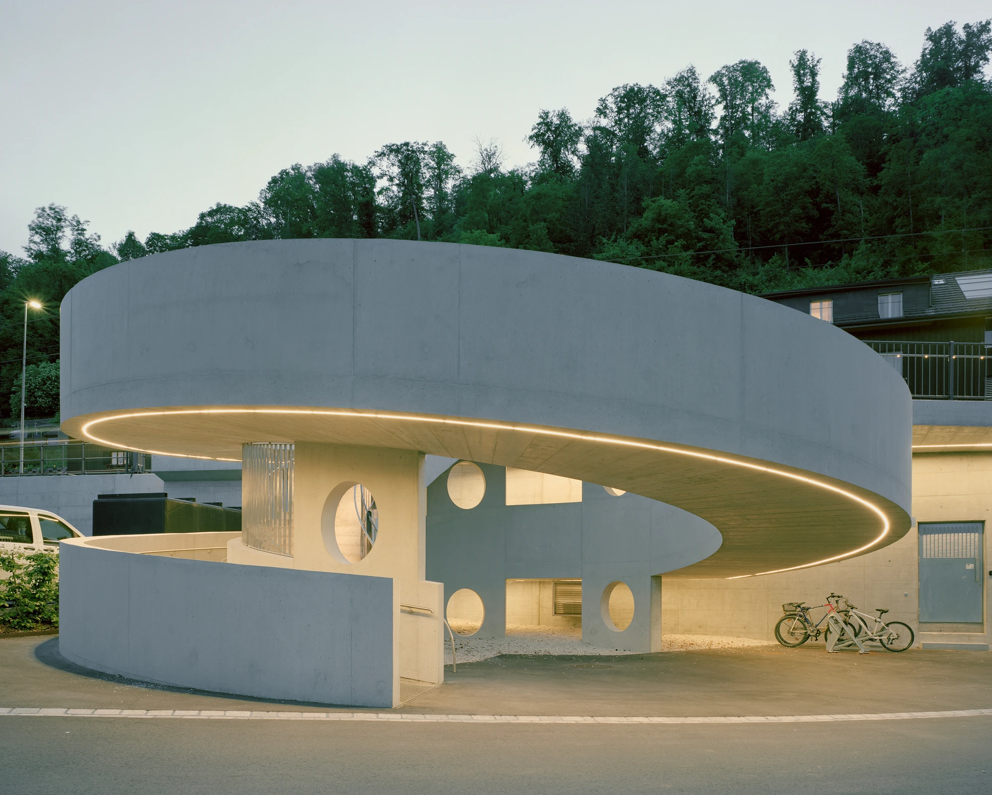 BLT Linie 19 Hölstein Süd tram stop by Raeto Studer Architekten in Switzerland, exposed concrete ramp and staircase infrastructure with 540-degree spiral and 55m concrete girder