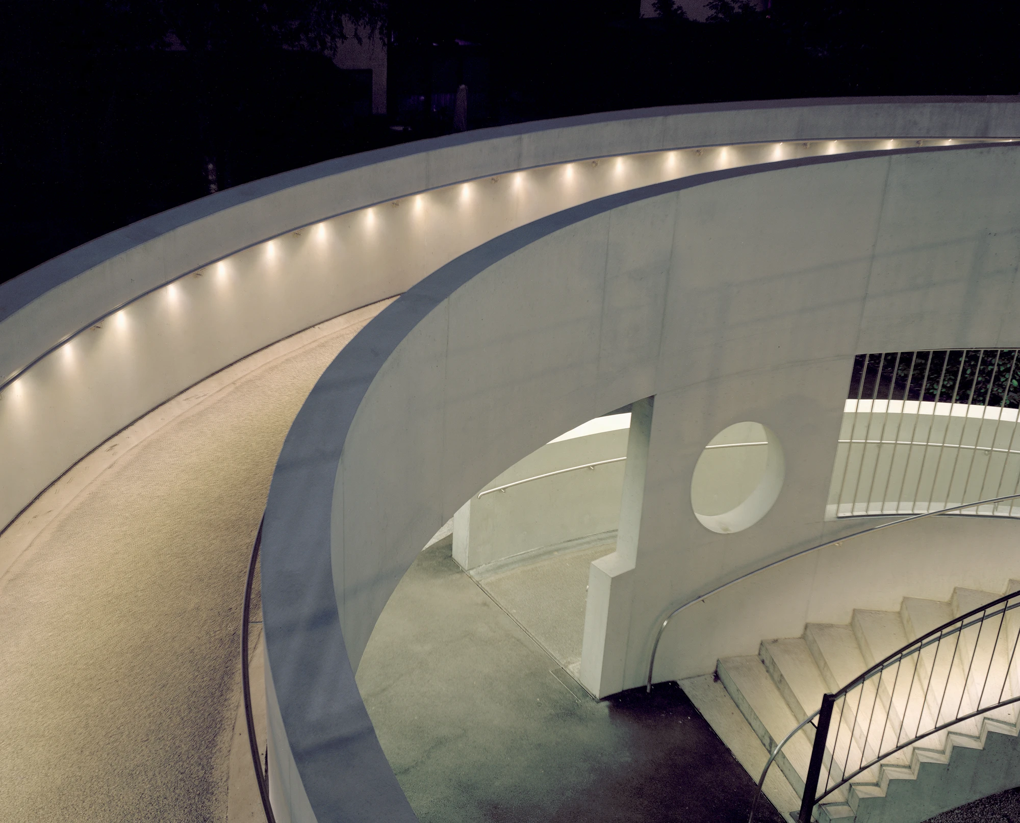 BLT Linie 19 Hölstein Süd tram stop by Raeto Studer Architekten in Switzerland, exposed concrete ramp and staircase infrastructure with 540-degree spiral and 55m concrete girder