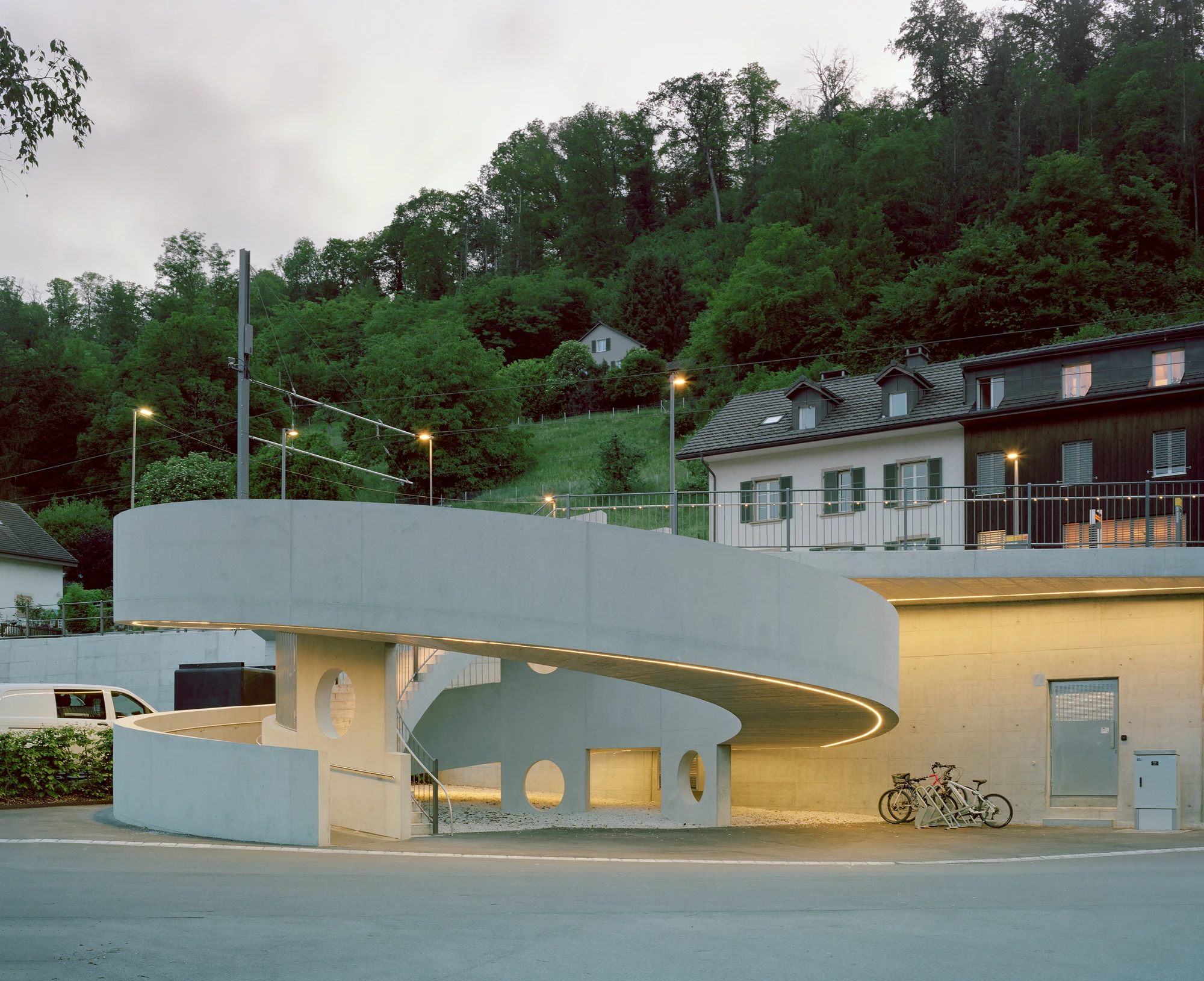 BLT Linie 19 Hölstein Süd tram stop by Raeto Studer Architekten in Switzerland, exposed concrete ramp and staircase infrastructure with 540-degree spiral and 55m concrete girder