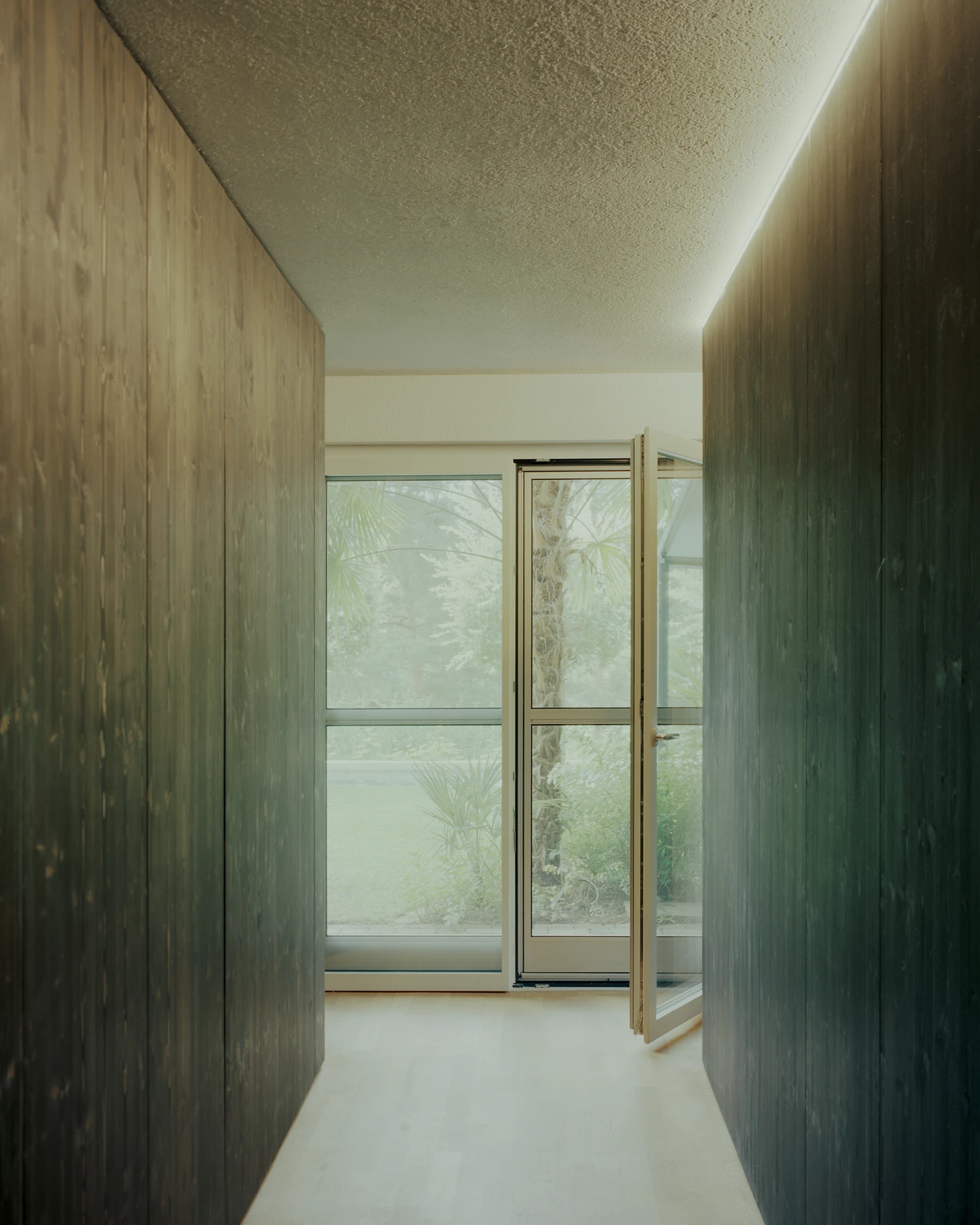 Attic Conversion in Riehen by Raeto Studer Architekten near Basel Switzerland, 1969 house renovation with black oiled cupboards soundproofed studio box clay plaster and PV roof