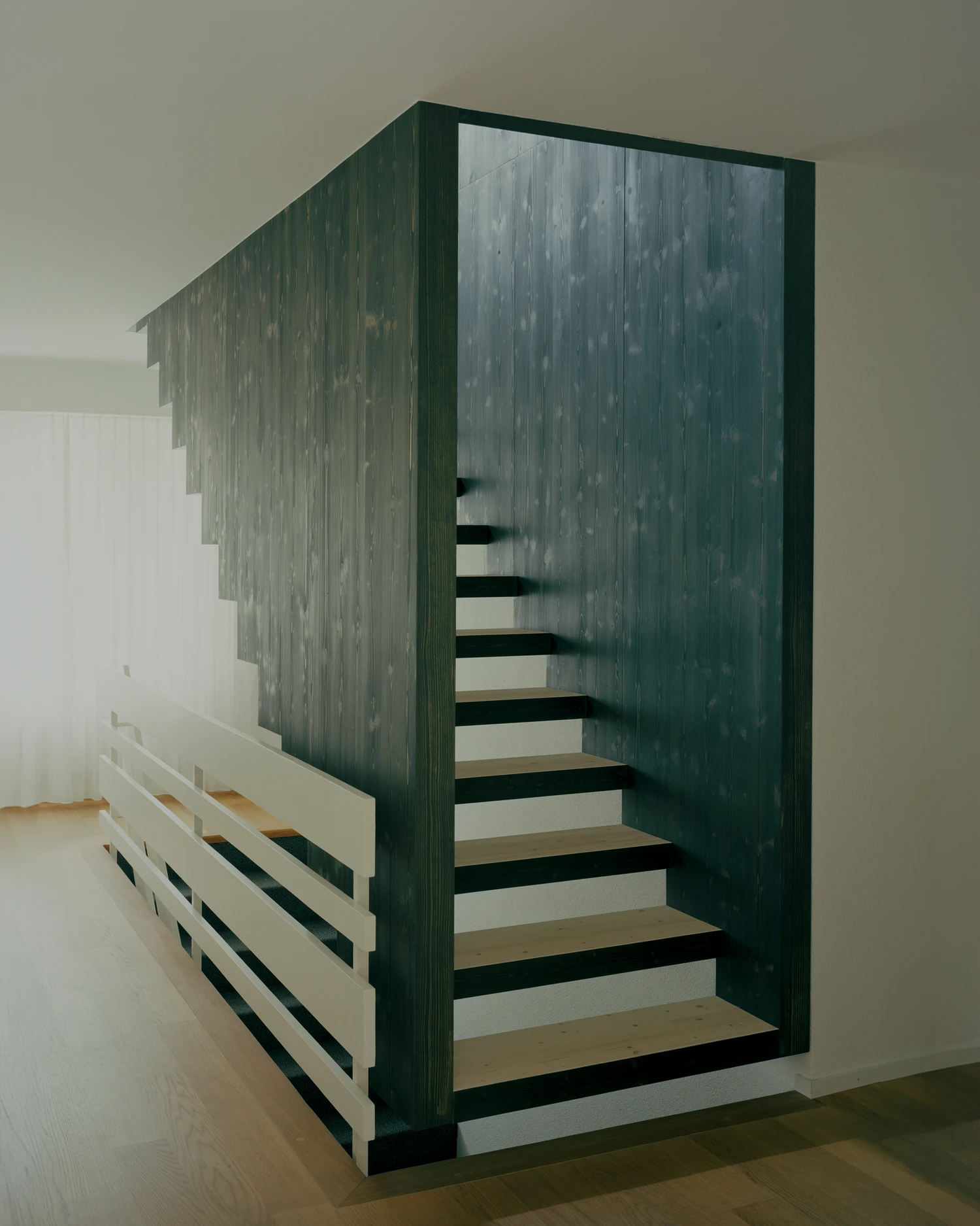 Attic Conversion in Riehen by Raeto Studer Architekten near Basel Switzerland, 1969 house renovation with black oiled cupboards soundproofed studio box clay plaster and PV roof