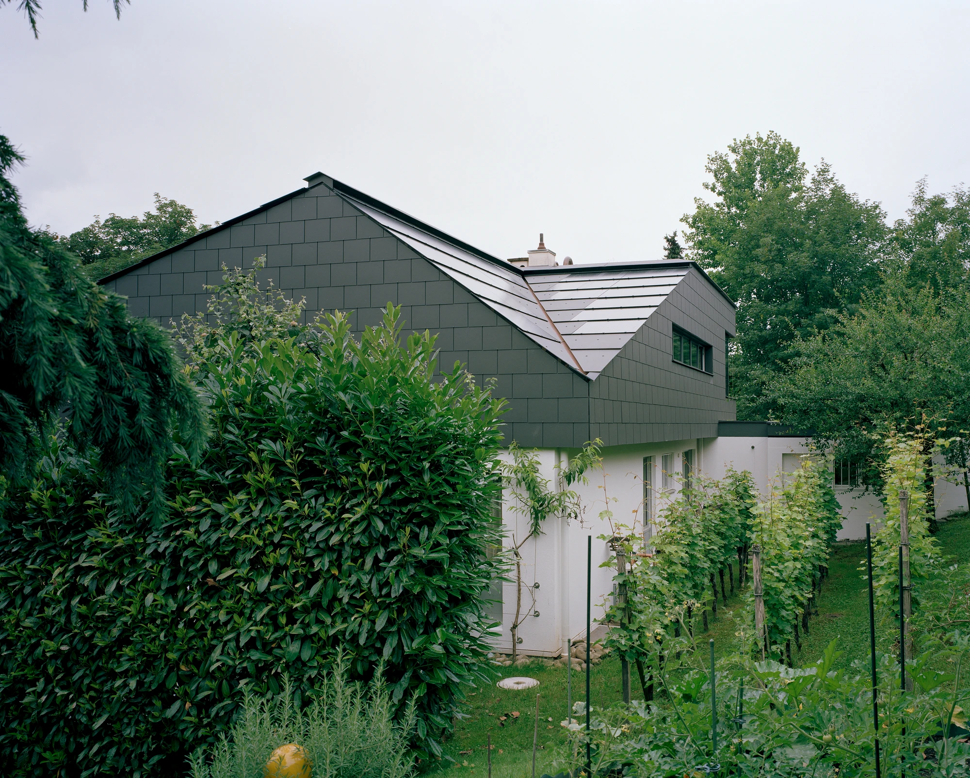 Attic Conversion in Riehen by Raeto Studer Architekten near Basel Switzerland, 1969 house renovation with black oiled cupboards soundproofed studio box clay plaster and PV roof