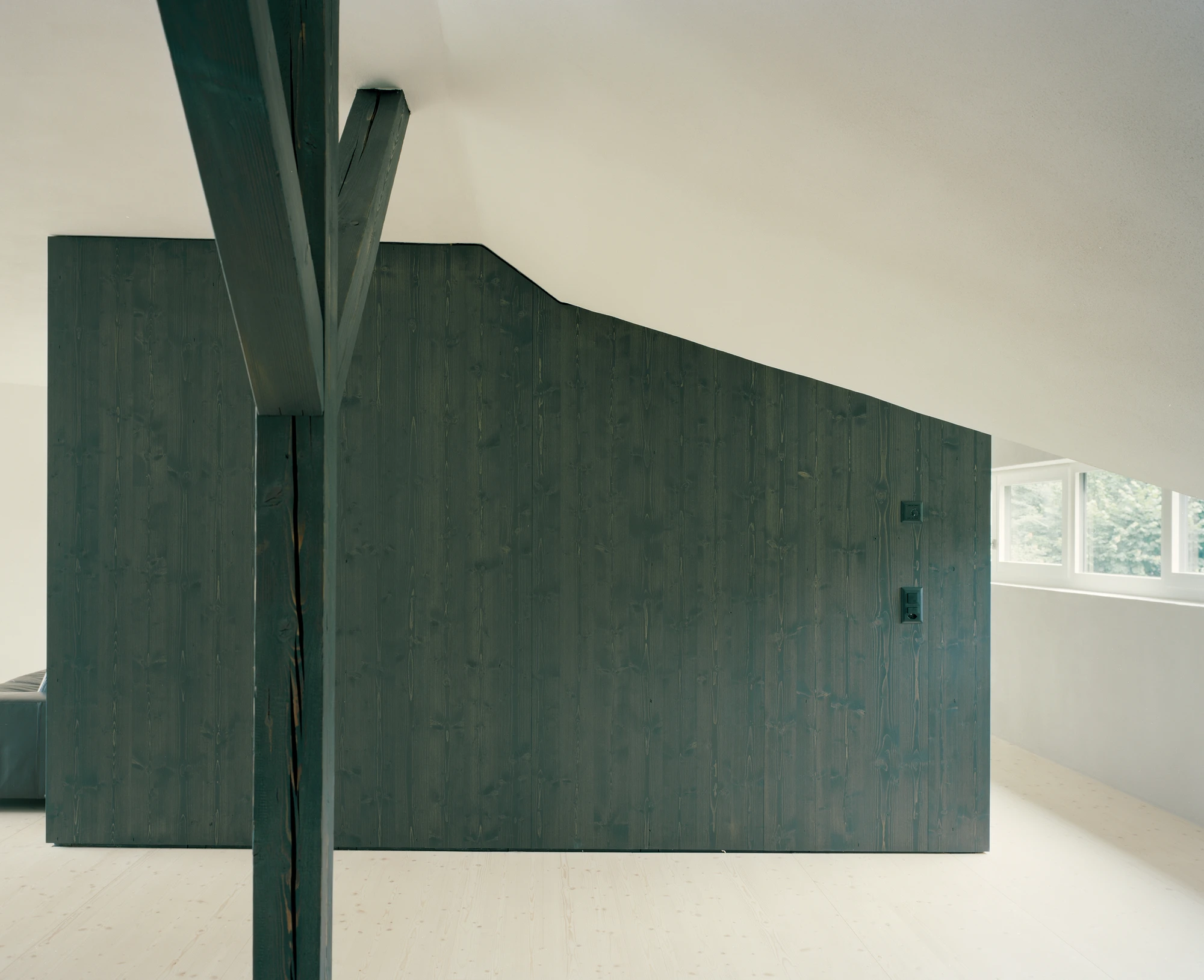 Attic Conversion in Riehen by Raeto Studer Architekten near Basel Switzerland, 1969 house renovation with black oiled cupboards soundproofed studio box clay plaster and PV roof