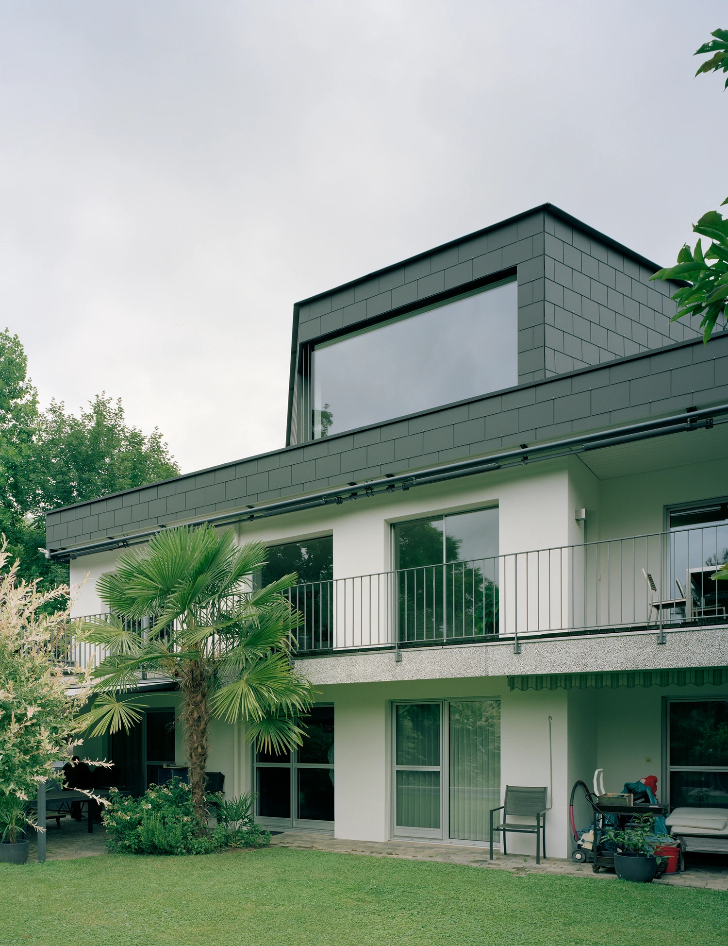 Attic Conversion in Riehen by Raeto Studer Architekten near Basel Switzerland, 1969 house renovation with black oiled cupboards soundproofed studio box clay plaster and PV roof