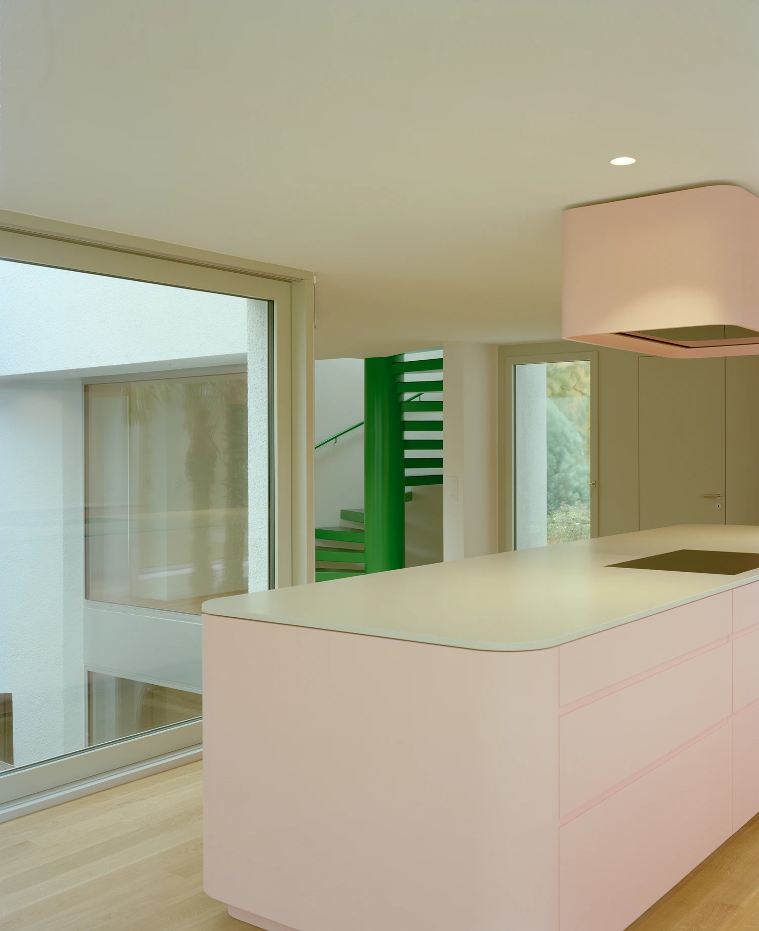 Kirschbaumweg renovation by Staehelin Meyer Architektur in Bottmingen Basel Switzerland, 1990s house with timber upper floor pink green colour scheme spiral staircase and lounger net