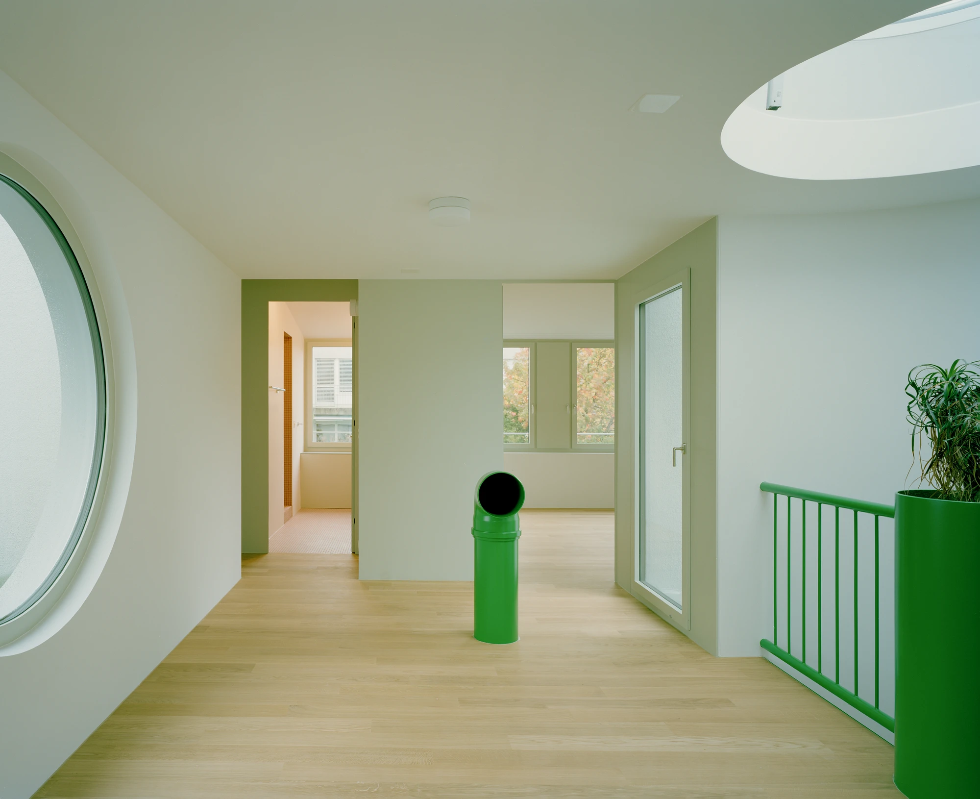 Kirschbaumweg renovation by Staehelin Meyer Architektur in Bottmingen Basel Switzerland, 1990s house with timber upper floor pink green colour scheme spiral staircase and lounger net