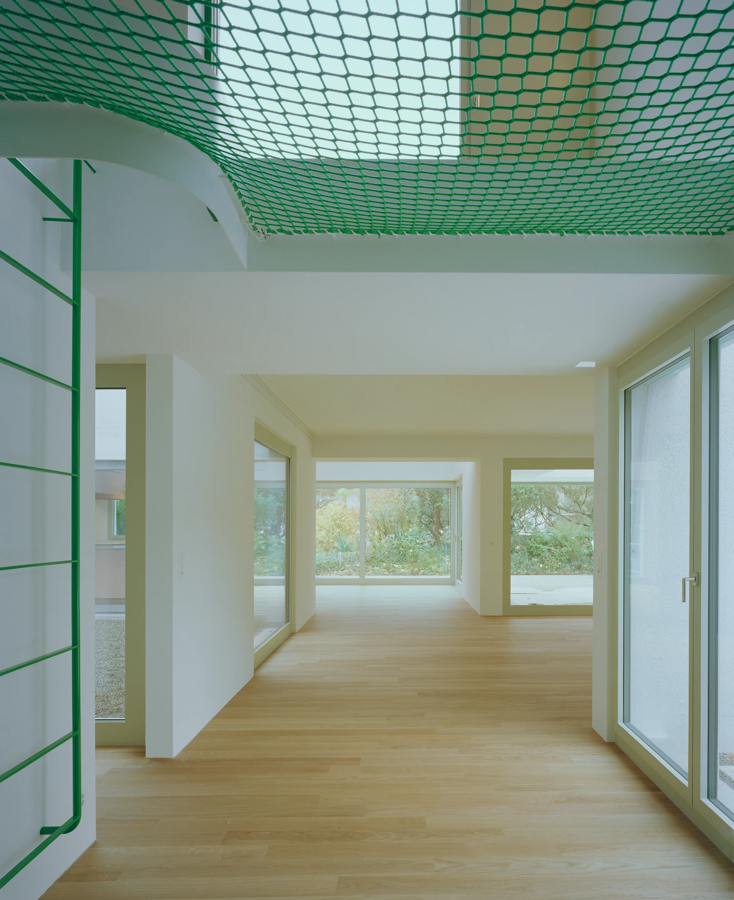 Kirschbaumweg renovation by Staehelin Meyer Architektur in Bottmingen Basel Switzerland, 1990s house with timber upper floor pink green colour scheme spiral staircase and lounger net