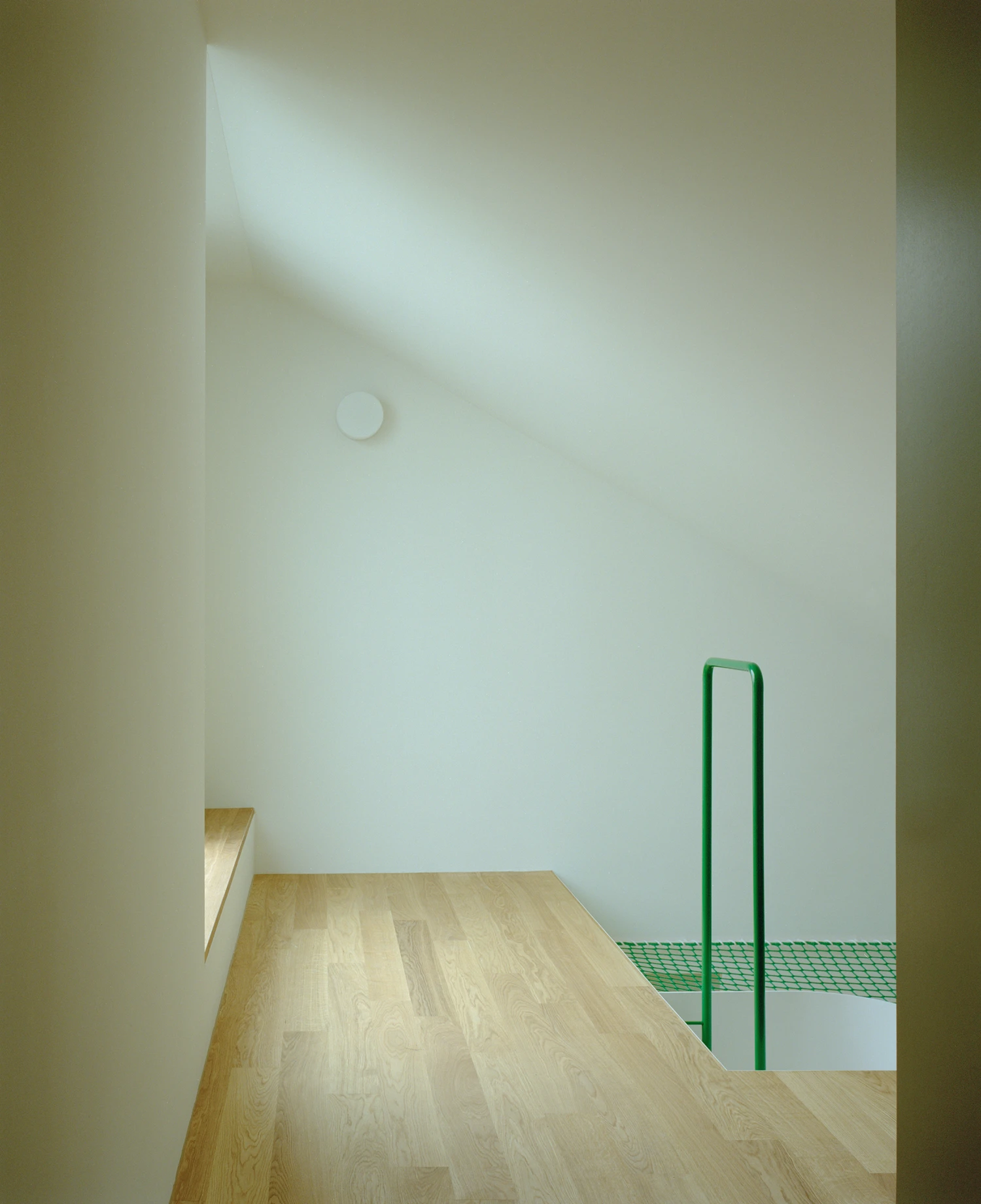 Kirschbaumweg renovation by Staehelin Meyer Architektur in Bottmingen Basel Switzerland, 1990s house with timber upper floor pink green colour scheme spiral staircase and lounger net