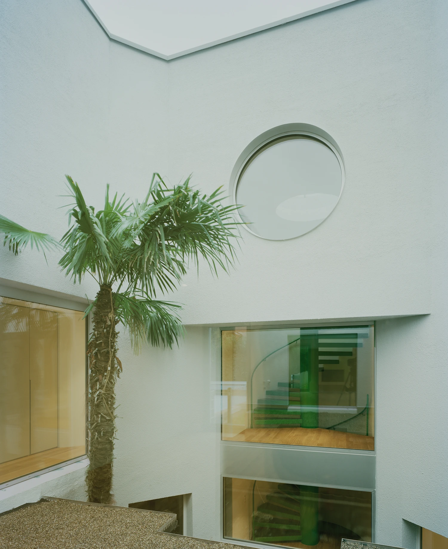 Kirschbaumweg renovation by Staehelin Meyer Architektur in Bottmingen Basel Switzerland, 1990s house with timber upper floor pink green colour scheme spiral staircase and lounger net
