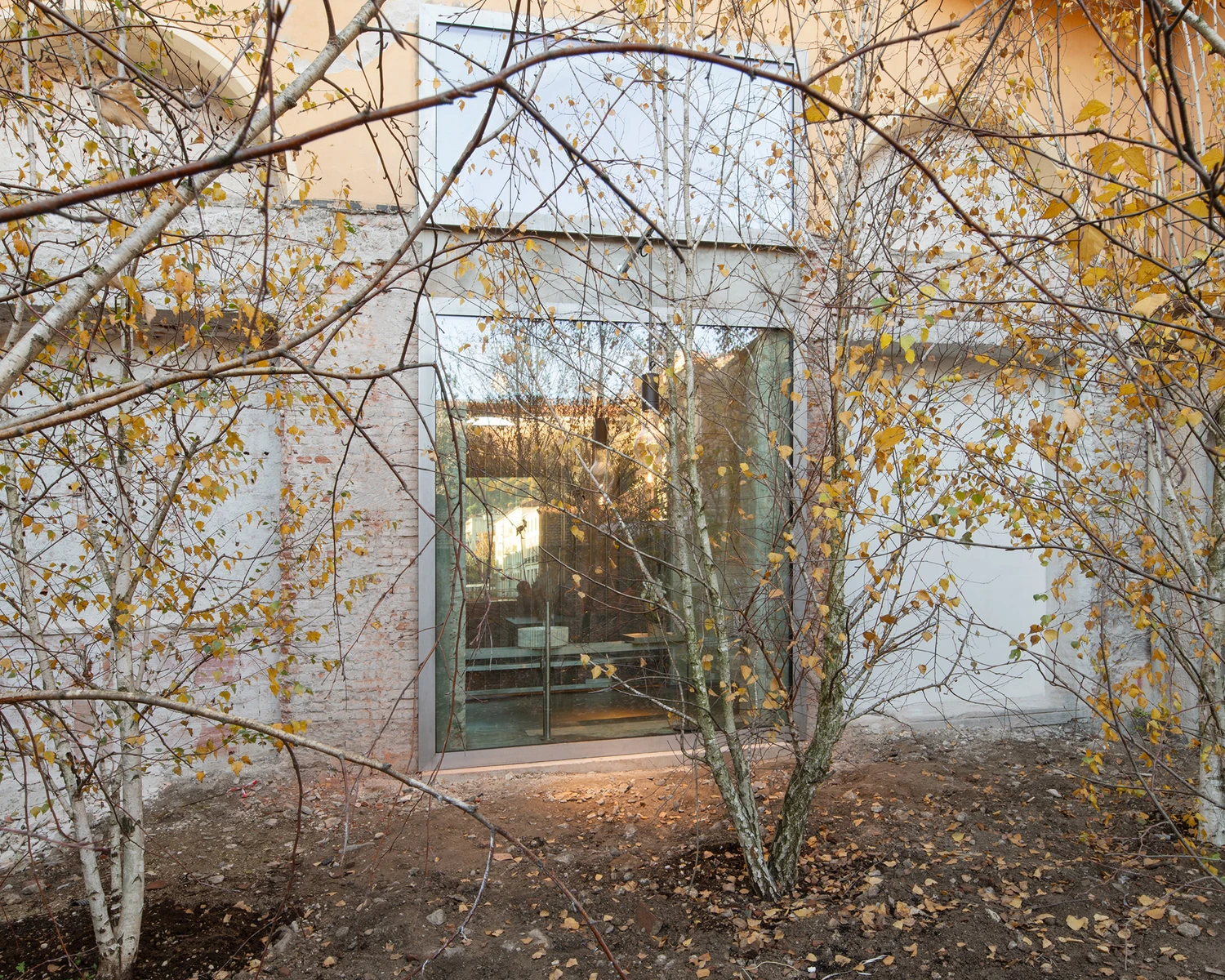 Caffè Nazionale by AMAA in Arzignano Italy, adaptive reuse of 19th-century palazzo with pleated stainless steel walls, okumè plywood ceiling and preserved historical patinas