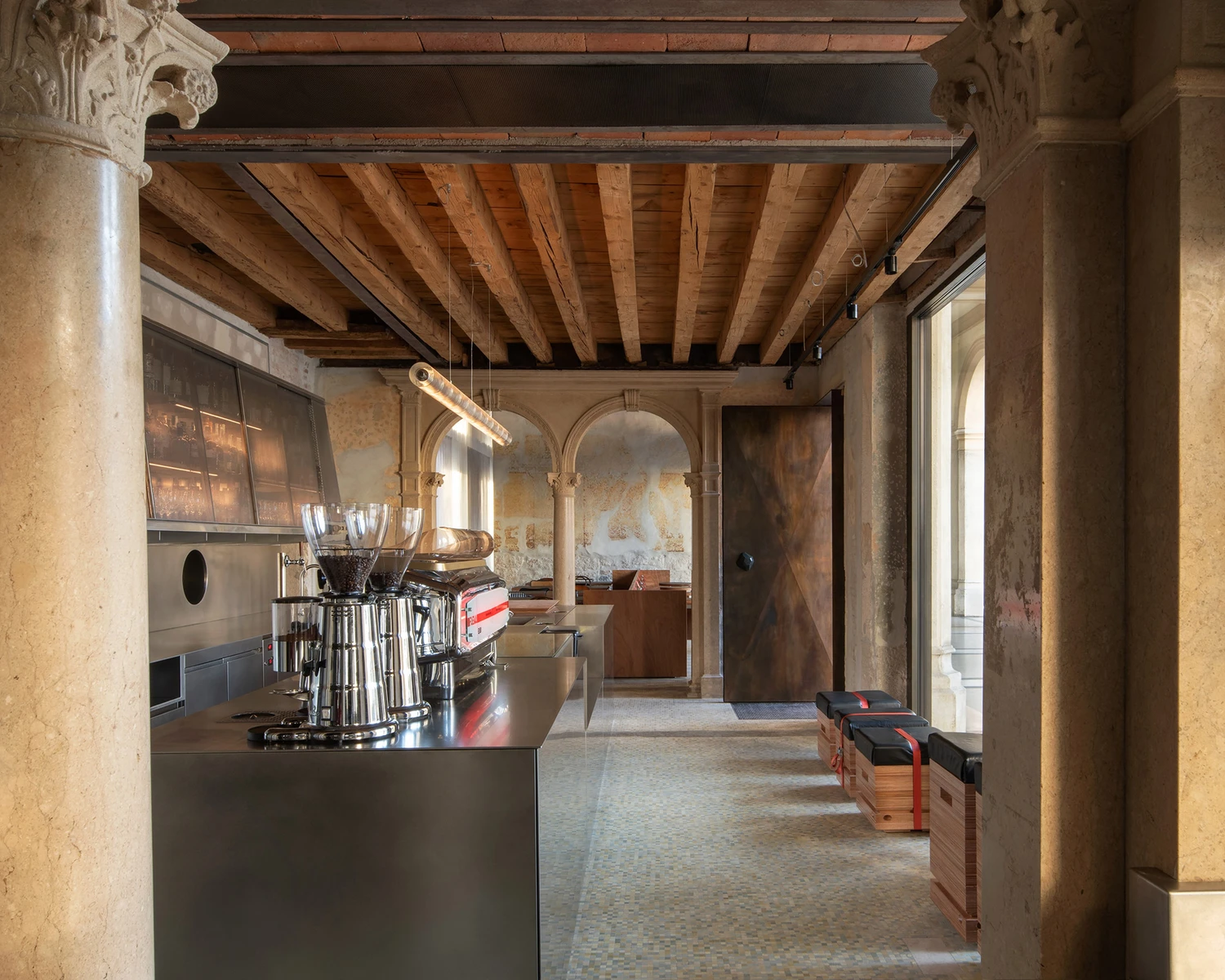 Caffè Nazionale by AMAA in Arzignano Italy, adaptive reuse of 19th-century palazzo with pleated stainless steel walls, okumè plywood ceiling and preserved historical patinas