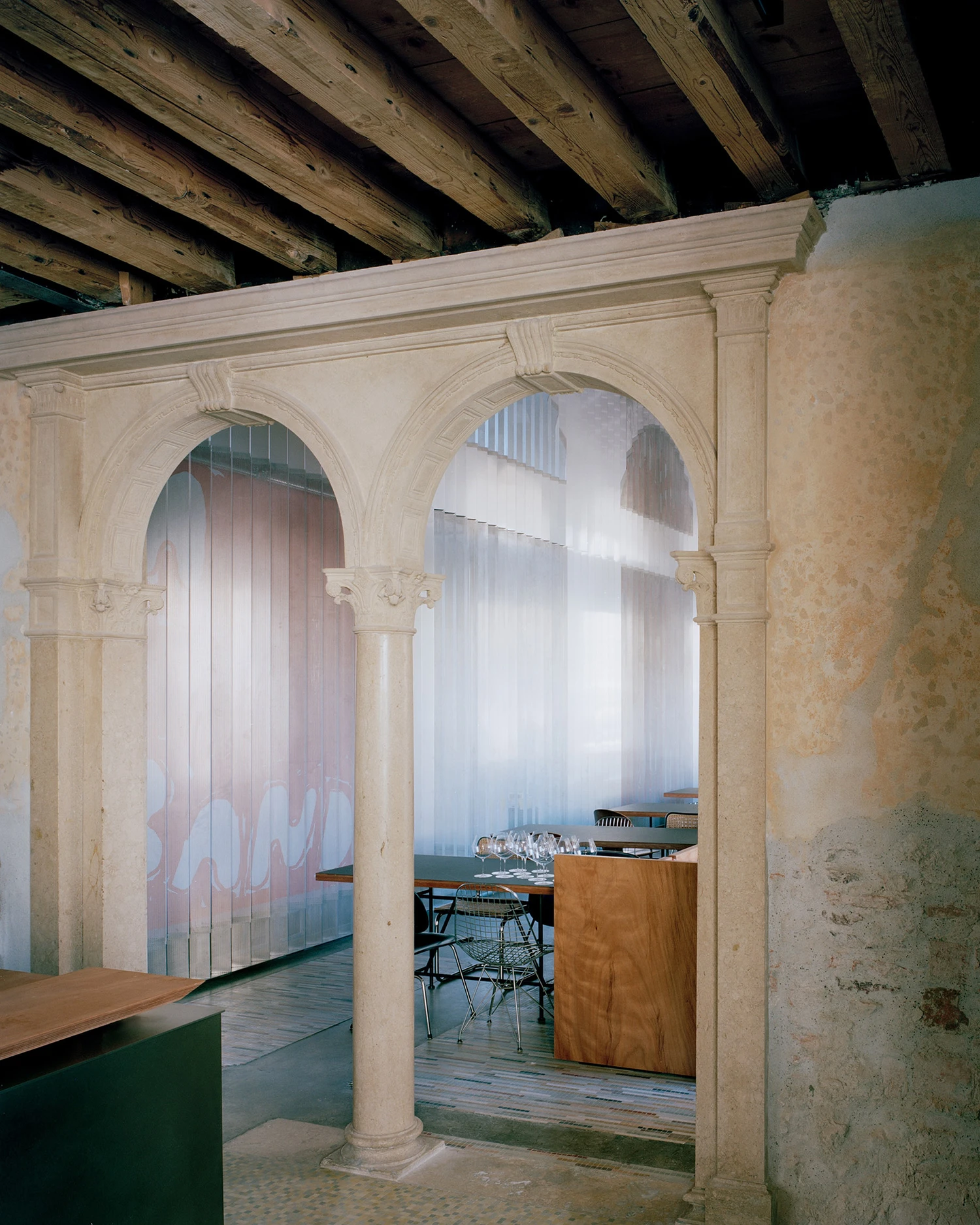 Caffè Nazionale by AMAA in Arzignano Italy, adaptive reuse of 19th-century palazzo with pleated stainless steel walls, okumè plywood ceiling and preserved historical patinas