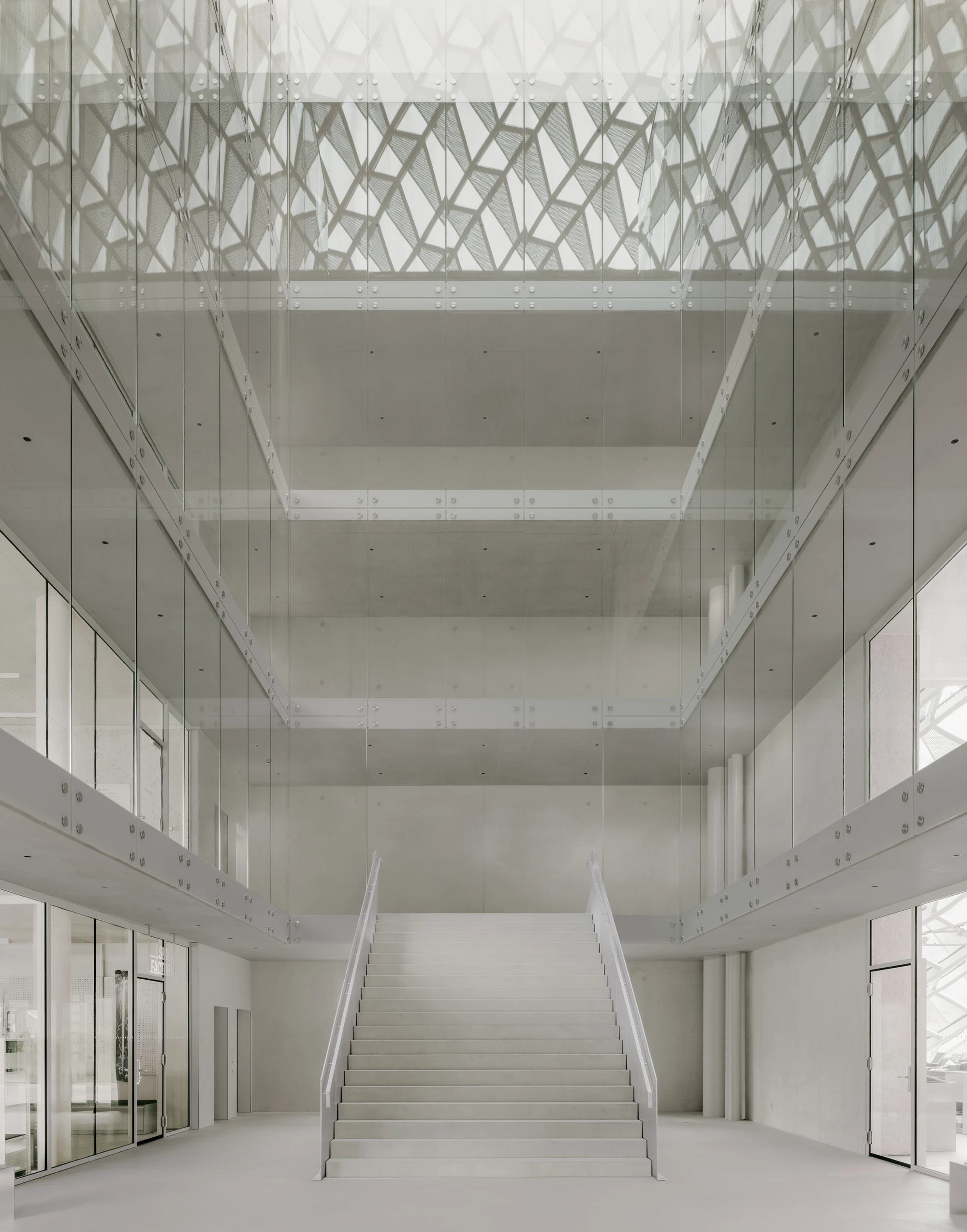 Dynafit Headquarters Speedfactory by Barozzi Veiga in Kiefersfelden Germany, twin pyramidal corporate building with diagonal metal lattice facade set against alpine landscape