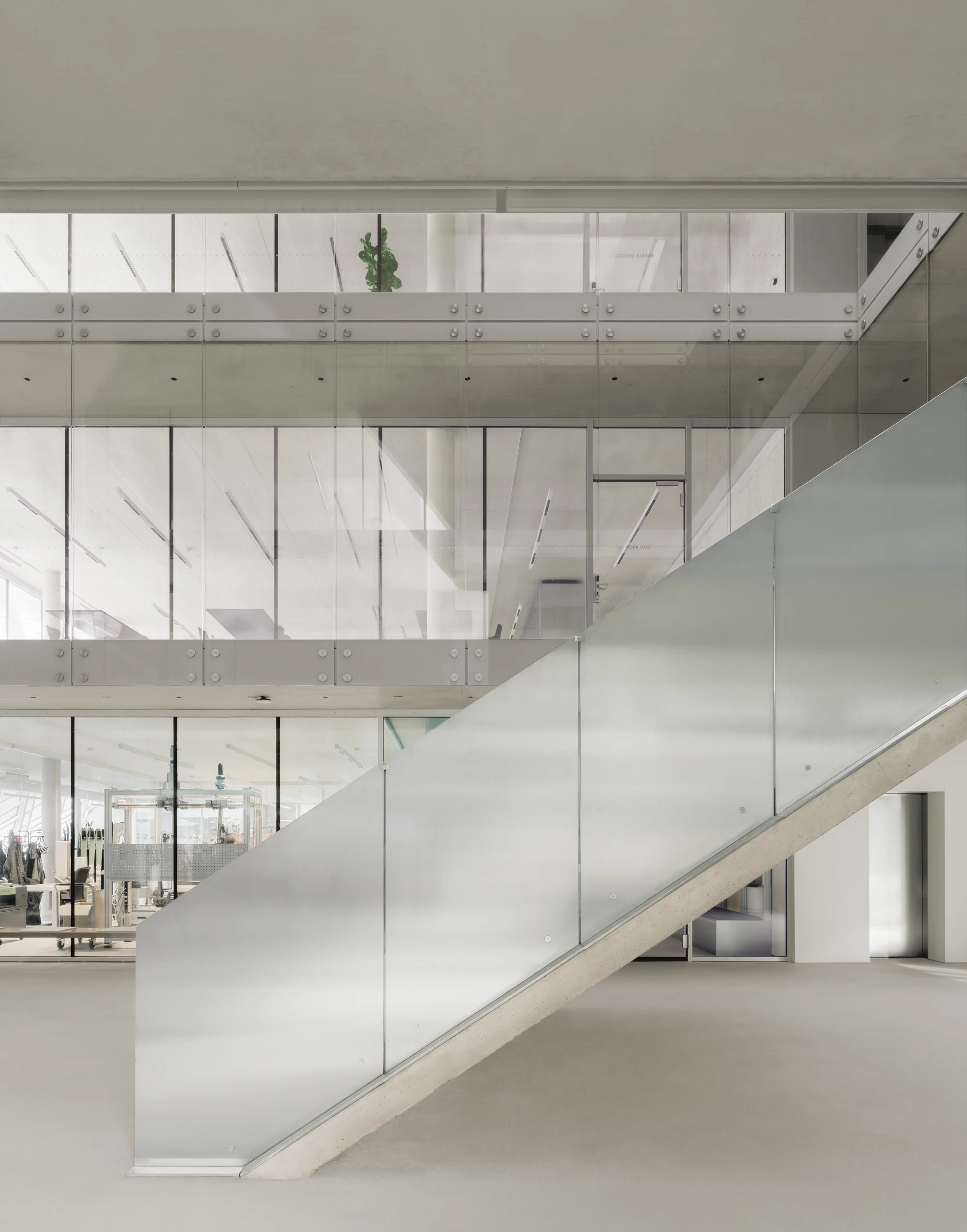 Dynafit Headquarters Speedfactory by Barozzi Veiga in Kiefersfelden Germany, twin pyramidal corporate building with diagonal metal lattice facade set against alpine landscape