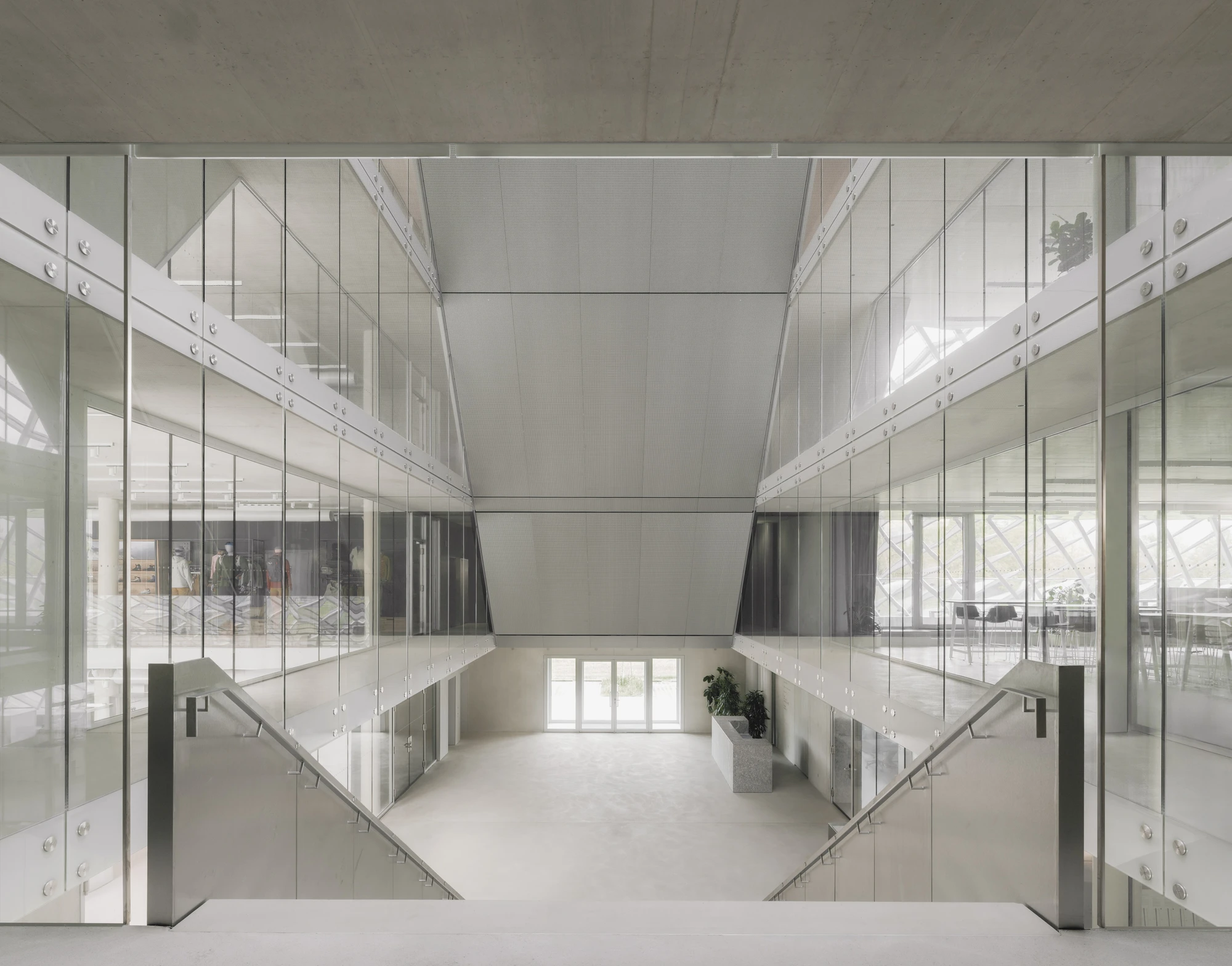 Dynafit Headquarters Speedfactory by Barozzi Veiga in Kiefersfelden Germany, twin pyramidal corporate building with diagonal metal lattice facade set against alpine landscape