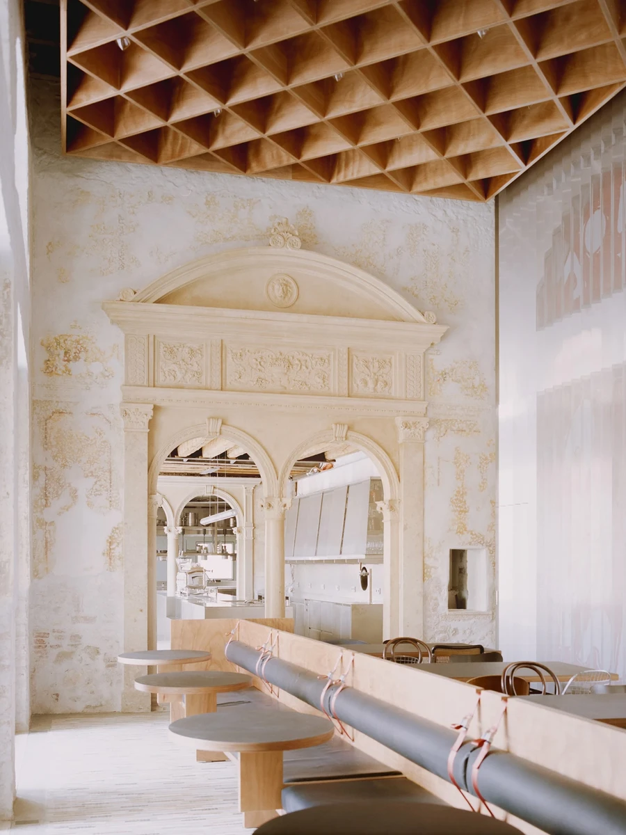 Caffè Nazionale by AMAA in Arzignano Italy, adaptive reuse of 19th-century palazzo with pleated stainless steel walls, okumè plywood ceiling and preserved historical patinas