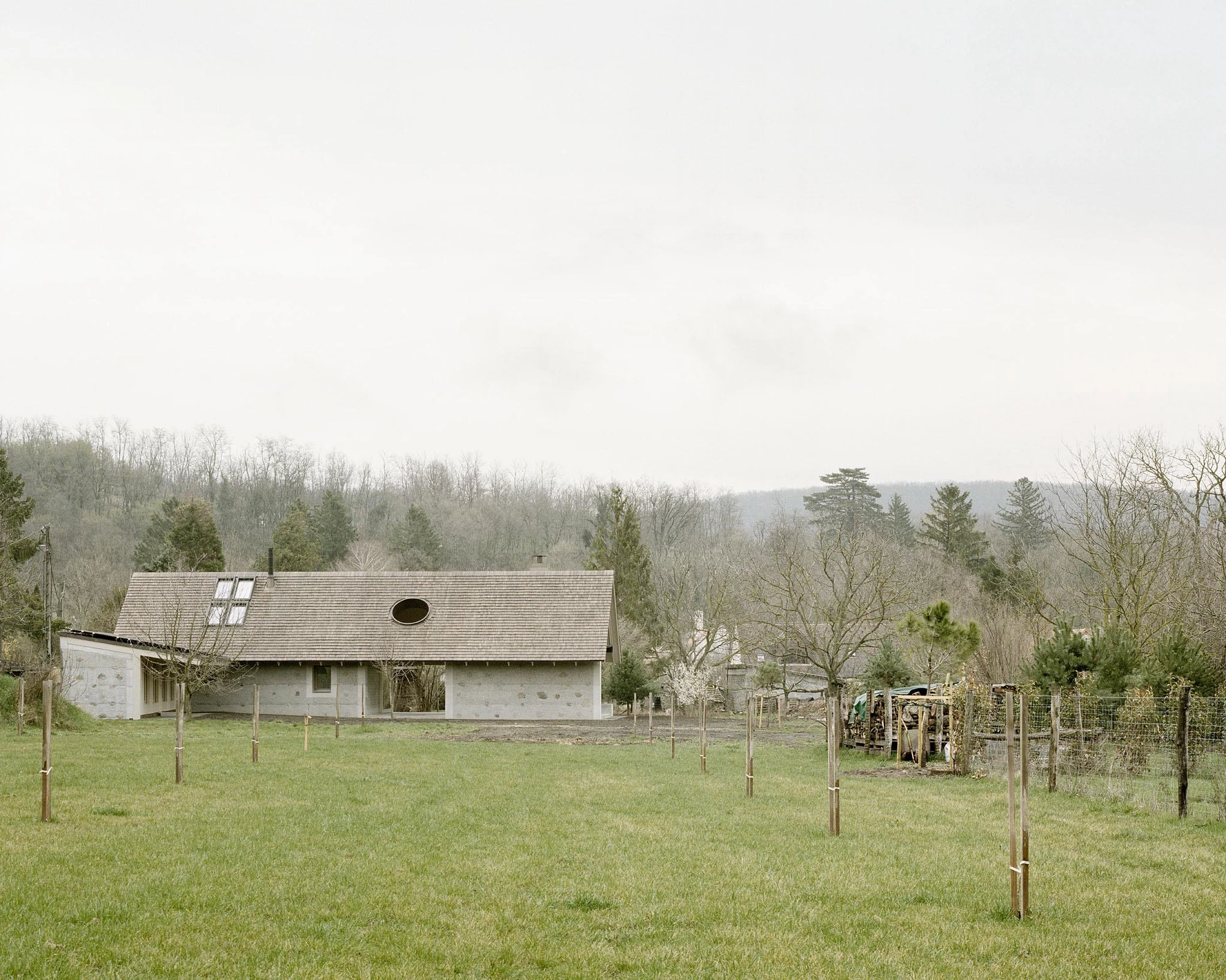 House and Beeyard by OKKA Architects, Western Hungary, rammed concrete, stone, wooden shingles, rural architecture