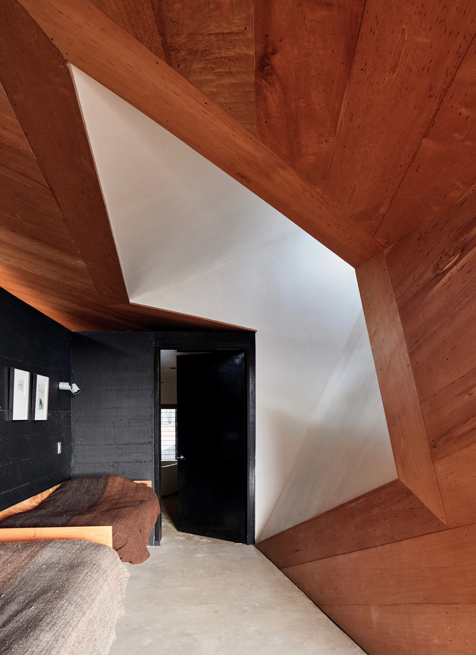 House for the Poem of the Right Angle by Smiljan Radić, Vilches, Chile, black concrete, cedar wood, rooflights, Le Corbusier