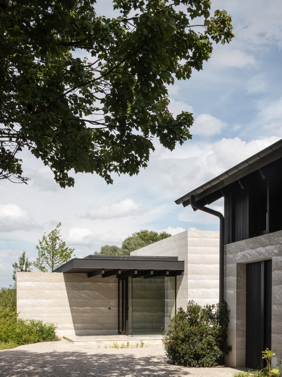 Villa WIGO by CAS Architecten — The L-plan geometry of Villa WIGO reads distinctly in this view, where two concrete volumes meet at a measured angle.