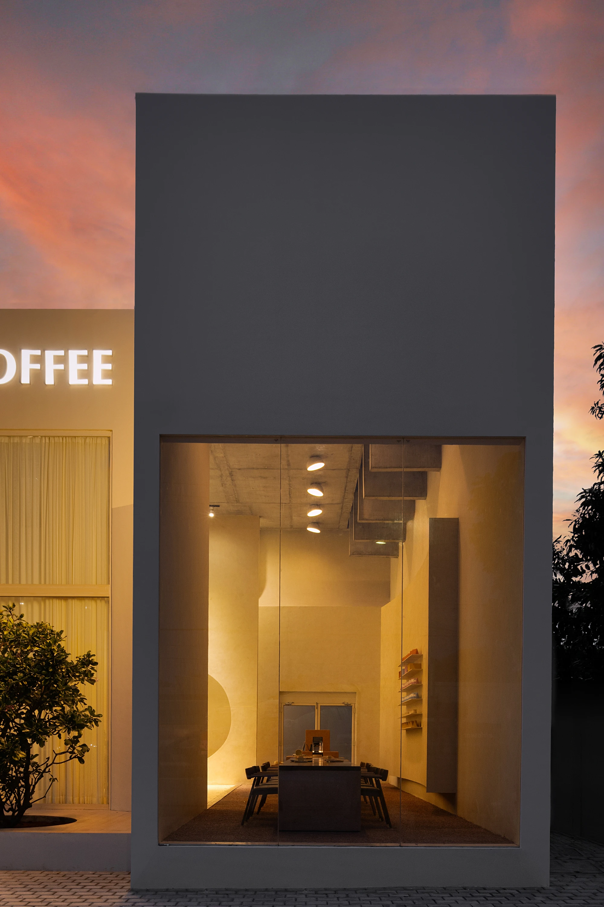 Eventide Coffee by BILLBOARDS in Chennai India, coastal cafe interior with elliptical counter and skylight, earthy tones and curved architectural elements inspired by the Madras beach