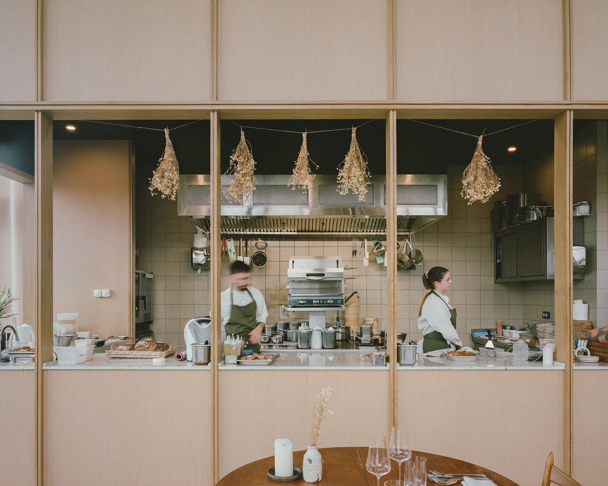 Restaurant Freia by Raum in Nantes France, glass greenhouse gourmet restaurant with rooftop garden on car park, minimalist interiors and cafe design