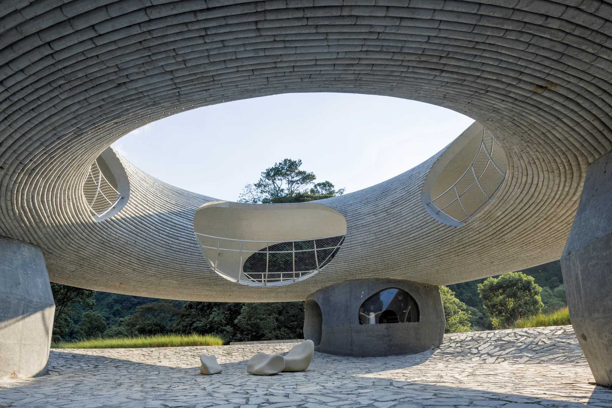 Resting Loop with Views by HCCH Studio — Interior view through the concrete ring reveals a monolithic structure engineered for landscape framing.