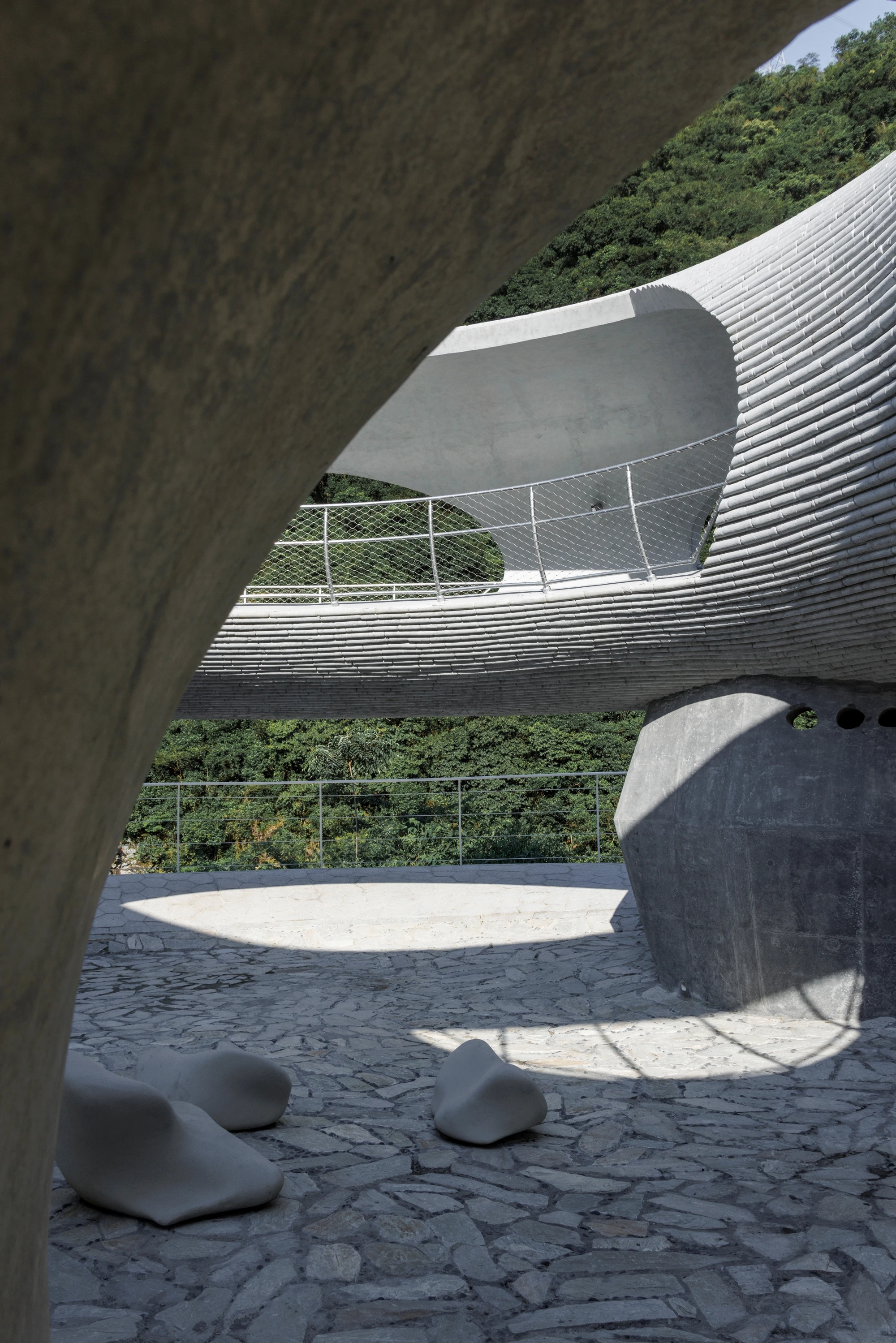 Resting Loop with Views by HCCH Studio — Photographed from within the concrete ring, the view frames multiple architectural and landscape layers.