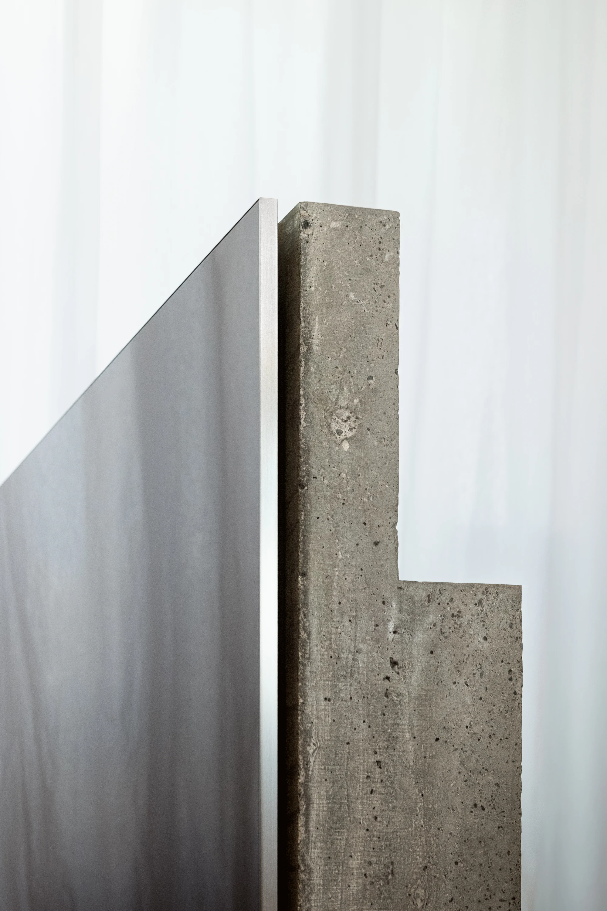 Concrete TV Stand by David Bard — David Bard's concrete TV stand presents an L-shaped monolith cast in expanded clay aggregate, its surface pitted with irregular craters and marked by...