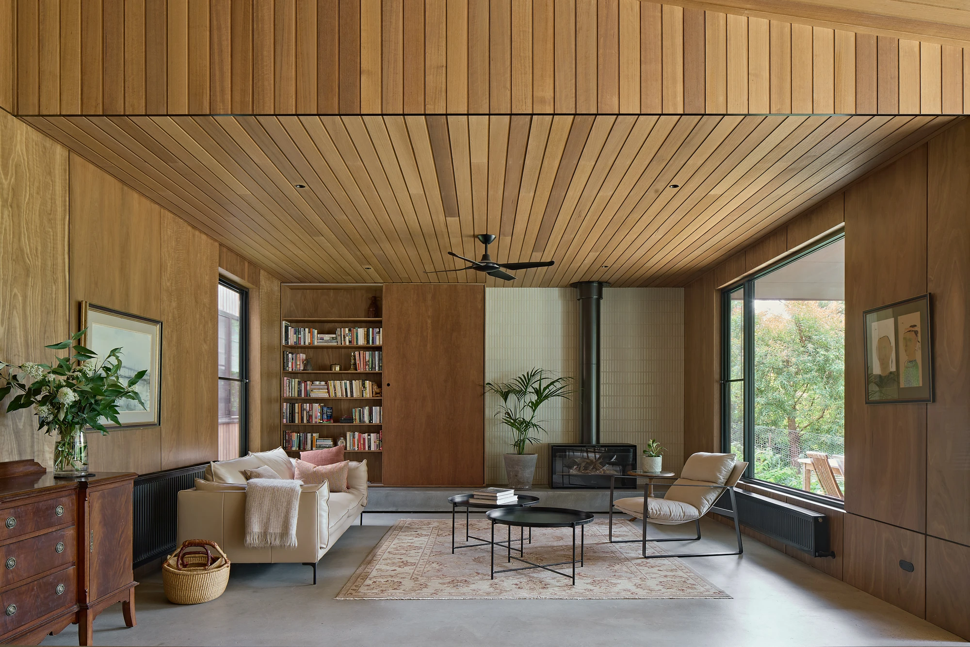 Homestead House by MRTN Architects — Interior view of Homestead House showing the open-plan living space defined by timber-clad walls and a linear plank ceiling.