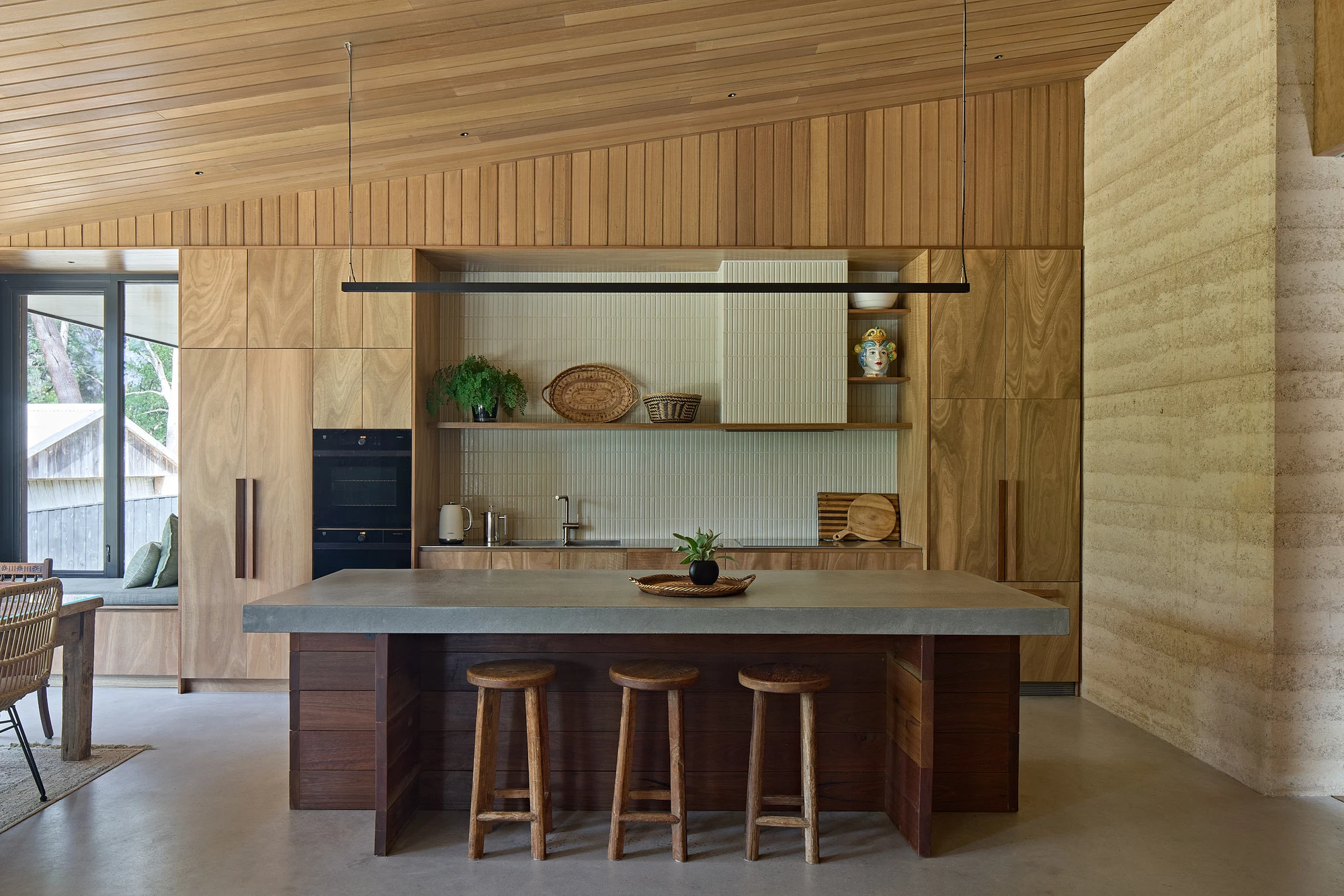 Homestead House by MRTN Architects — The kitchen interior presents a material study in warm timber and dark joinery.
