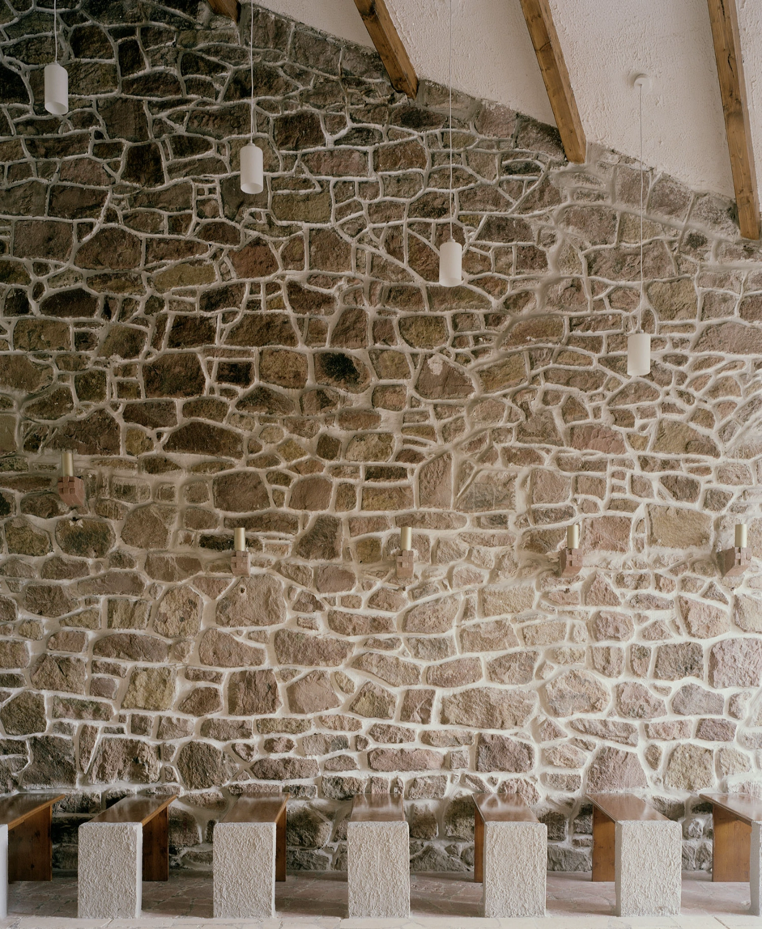 Restoration of the Church of Cserépváralja by Partizan Architecture — The restored interior of Cserépváralja Church reveals the material dialogue between its 1962 construction phases.