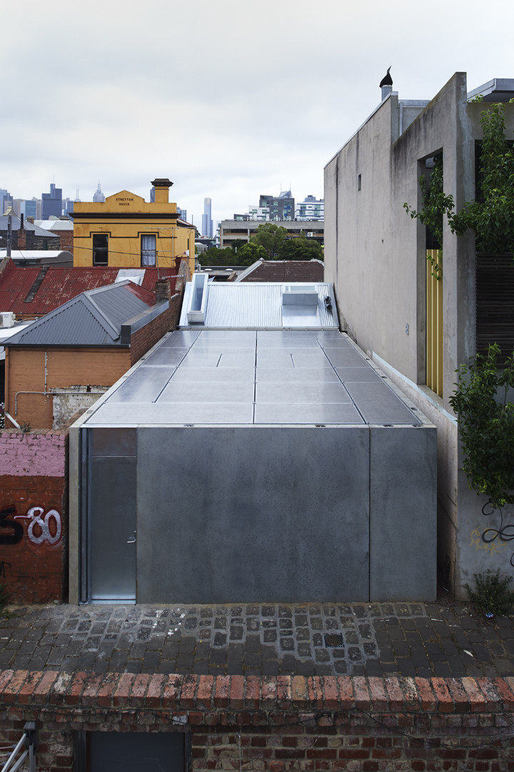Green House by Sean Godsell — The Green House addition presents itself as a monolithic concrete volume rising behind the retained heritage cottage, its flat roof plane punctuated by...